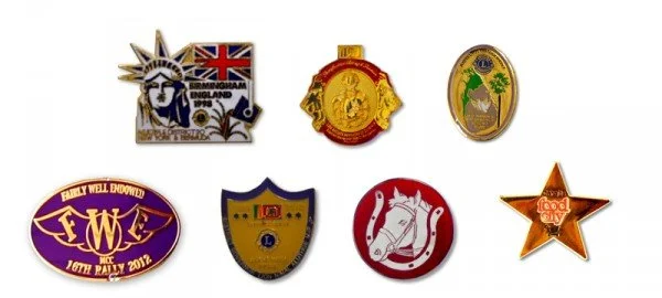 Six embroidered patches with various designs and logos arranged in a row.