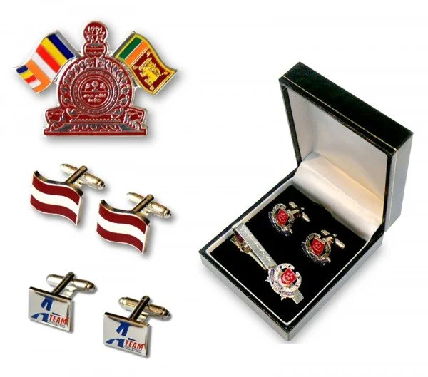 Set of three pairs of cufflinks and a box with a military badge and lapel pin. The cufflinks include one with red and white stripes, another with a blue and white design, and a third with the logo of the Atlanta Braves baseball team. The box contains