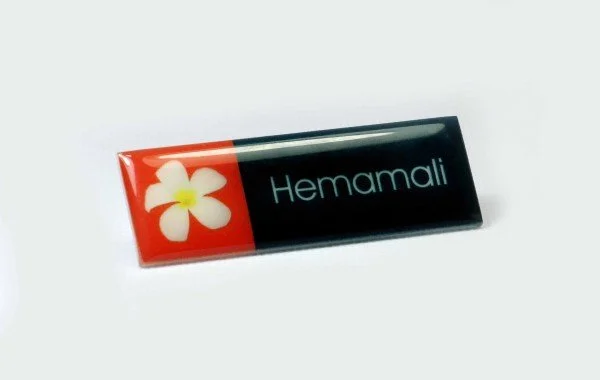 A box of Hemamali herbal medicine with a white flower logo on a black and red background.