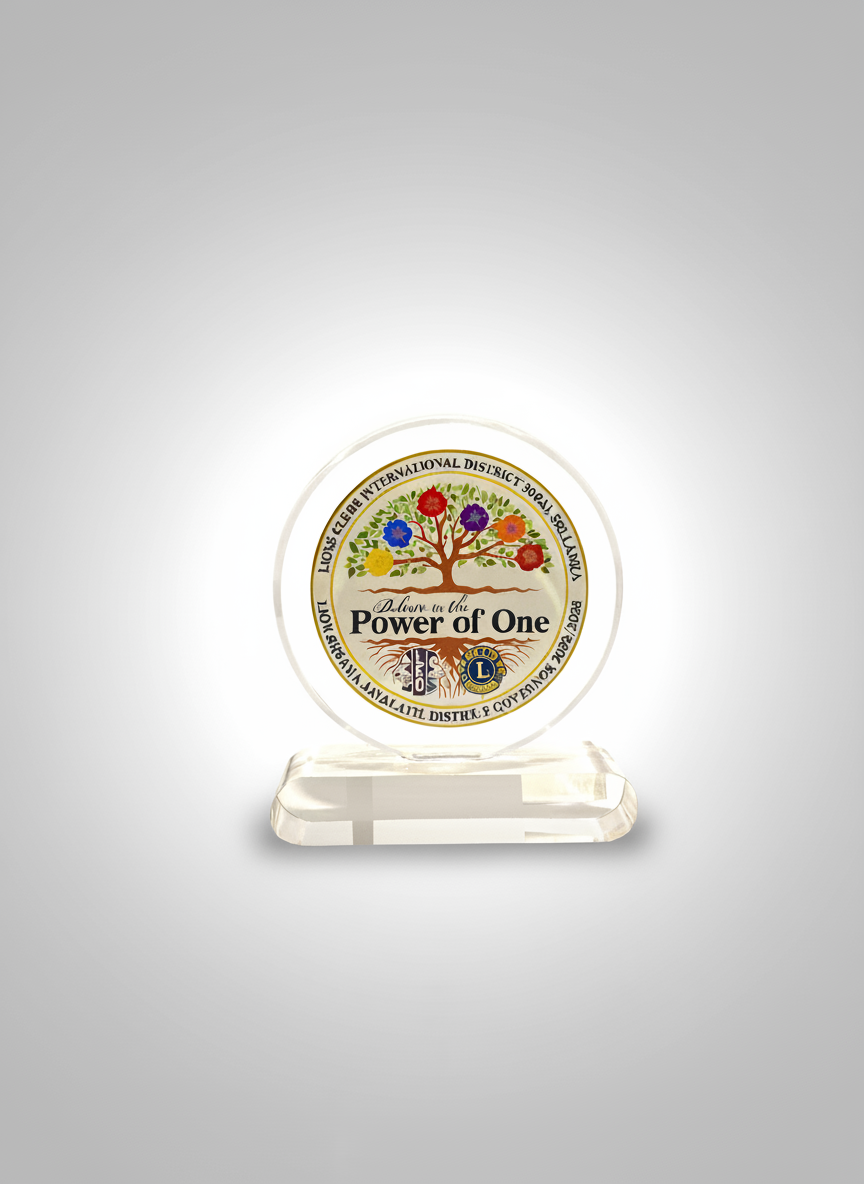 A clear glass award with a colorful tree illustration and the text 'Delve into the Power of One' inside a circular design, set on a small glass stand.