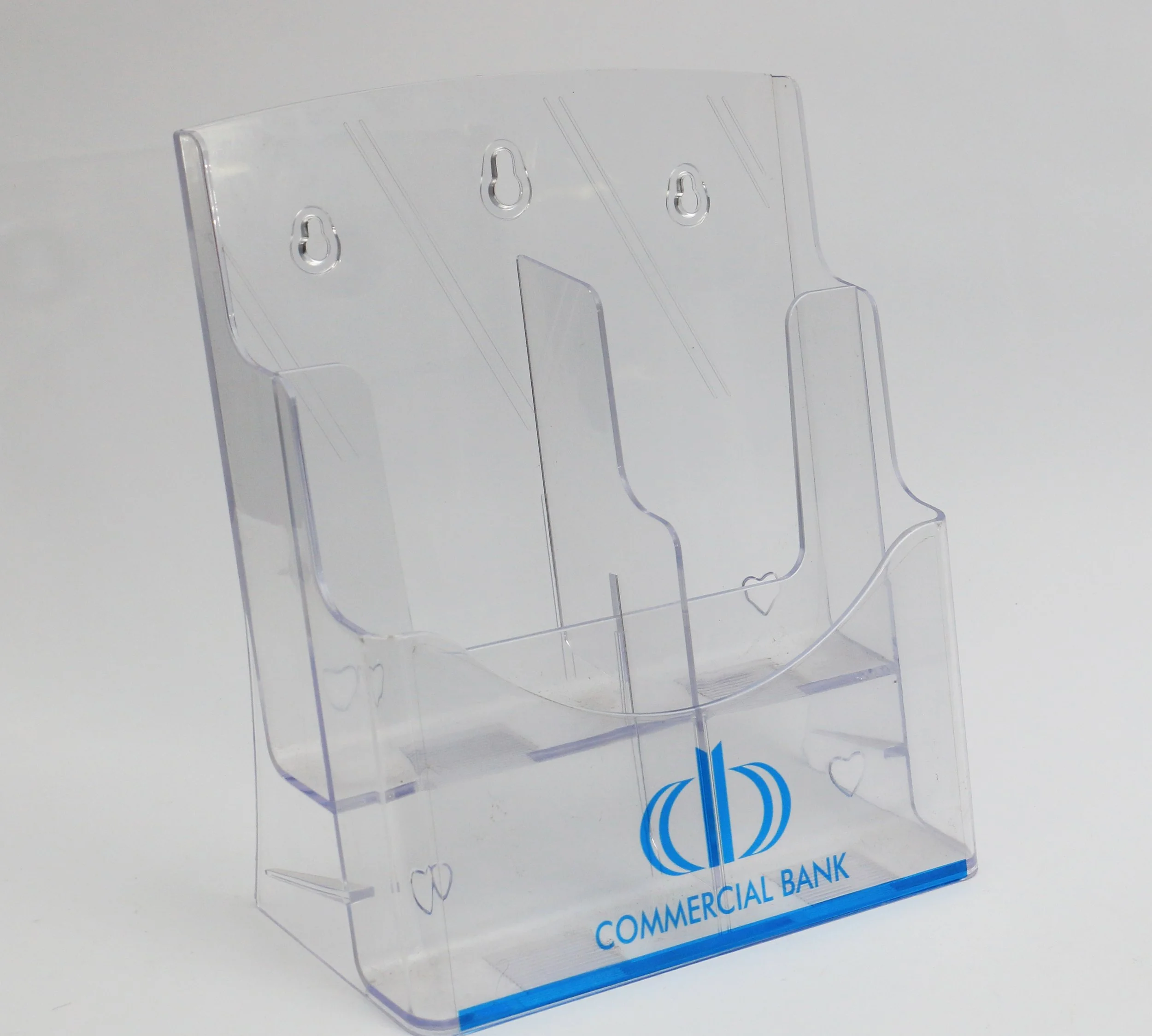 Clear acrylic sign holder with a blue logo at the bottom, displaying the words 'COMMERCIAL BANK'.
