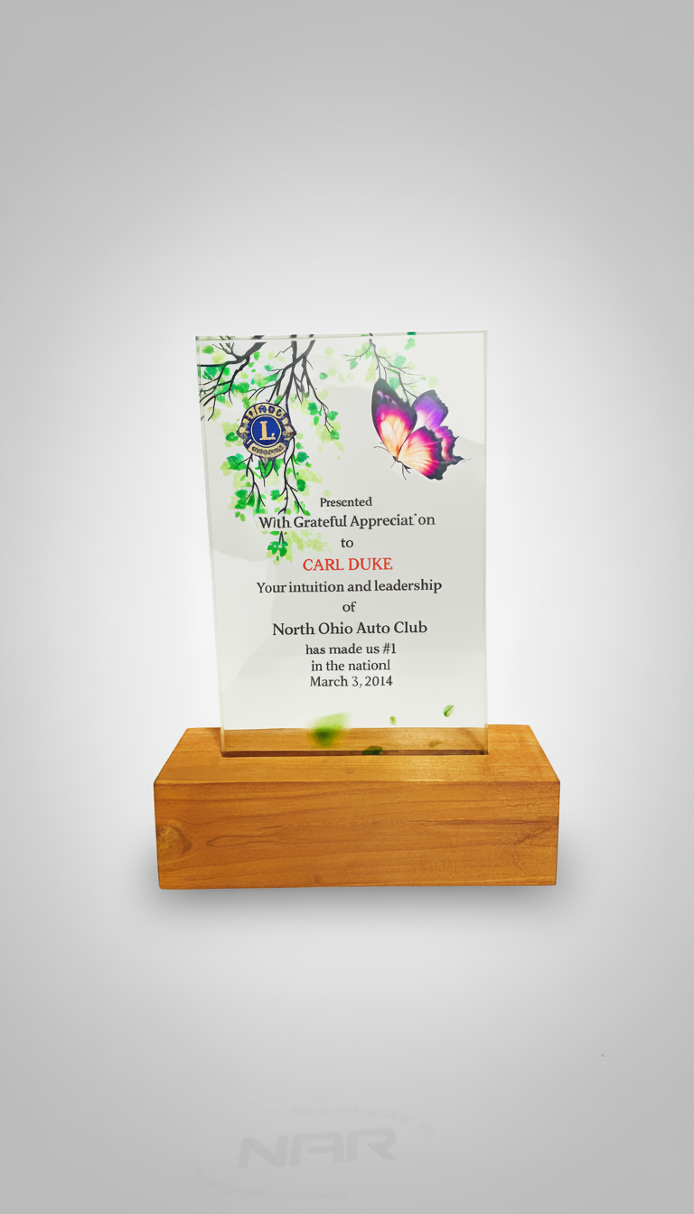 Glass award with a butterfly and tree branch design, mounted on a wooden base, presented to Carl Duke by North Ohio Auto Club on March 3, 2014.