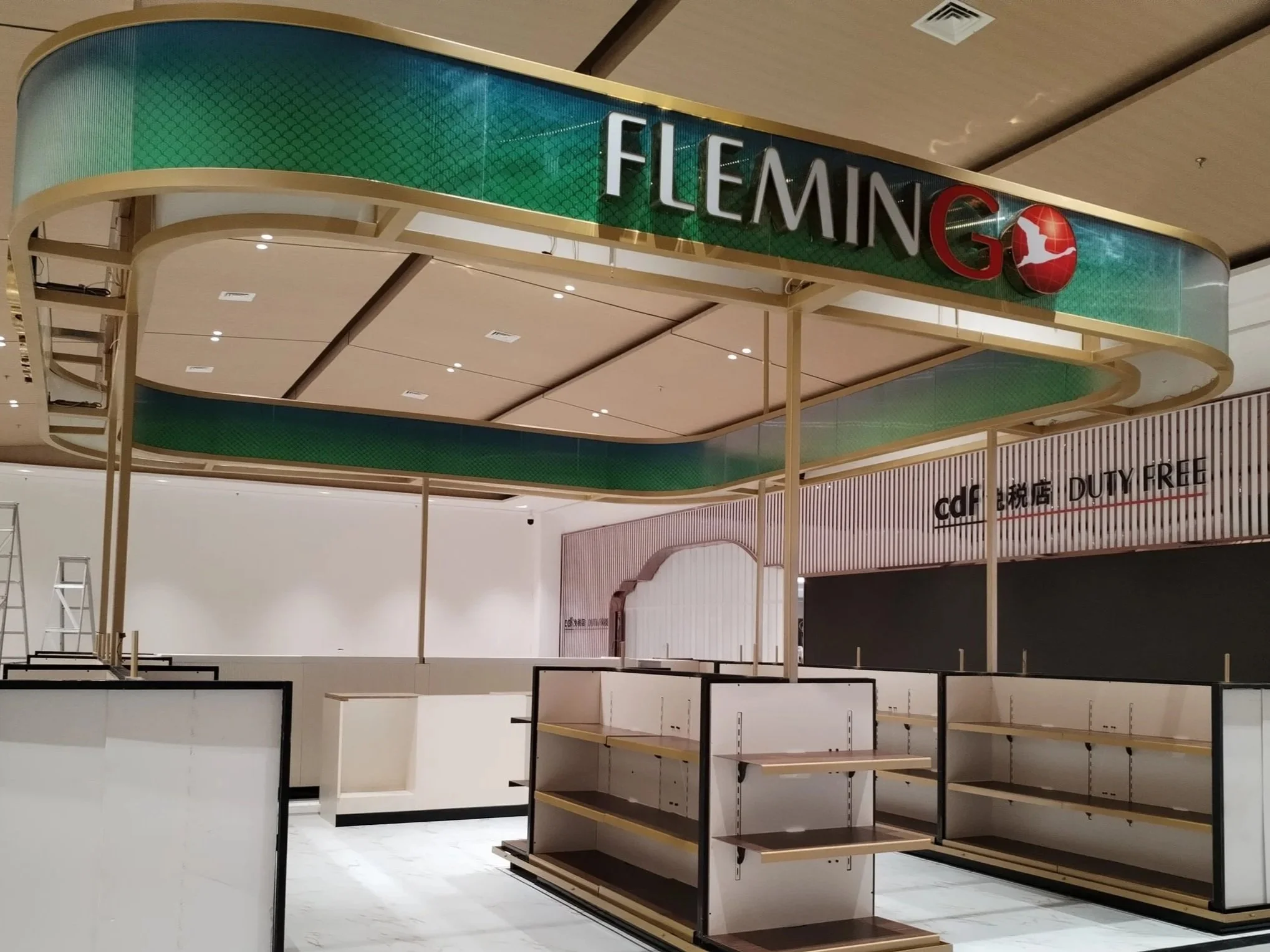 Empty retail shelves with metal framing in a shopping mall.