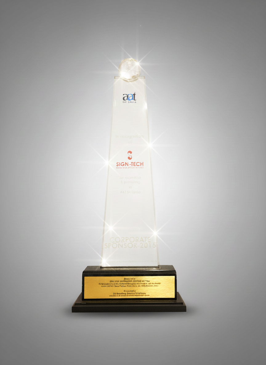 Crystal trophy with a spherical top, inscribed with logos and text, mounted on a black base with a gold plaque.