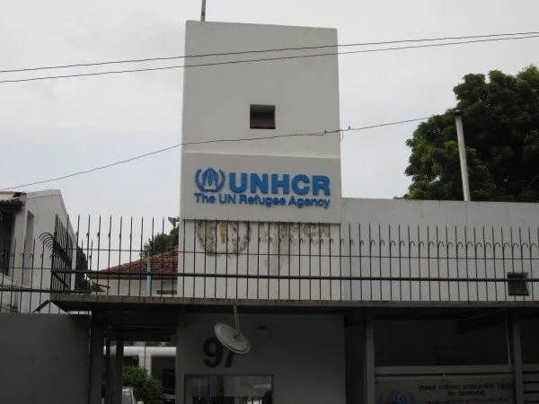 Building with UNHCR logo and sign reading "The UN Refugee Agency"