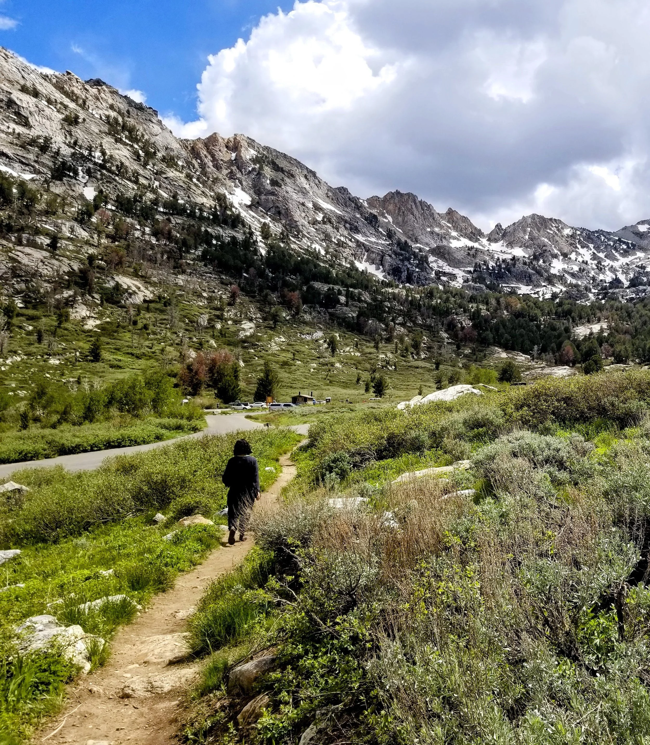 walking on your path to health with mountains and greenery and blue sky and clouds