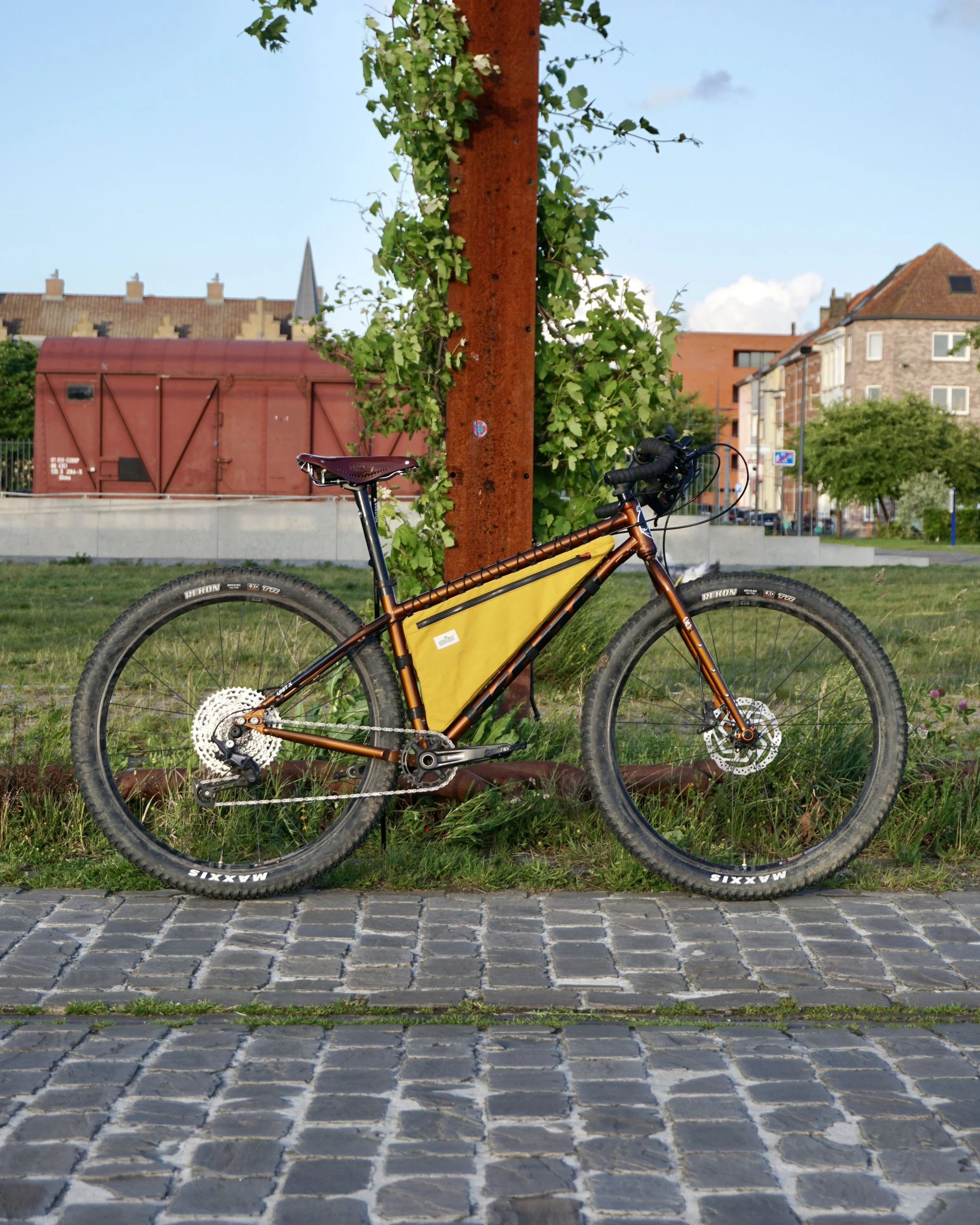 Kona Unit X steel mtb with Surly corner bars and a yellow custom made frame bag