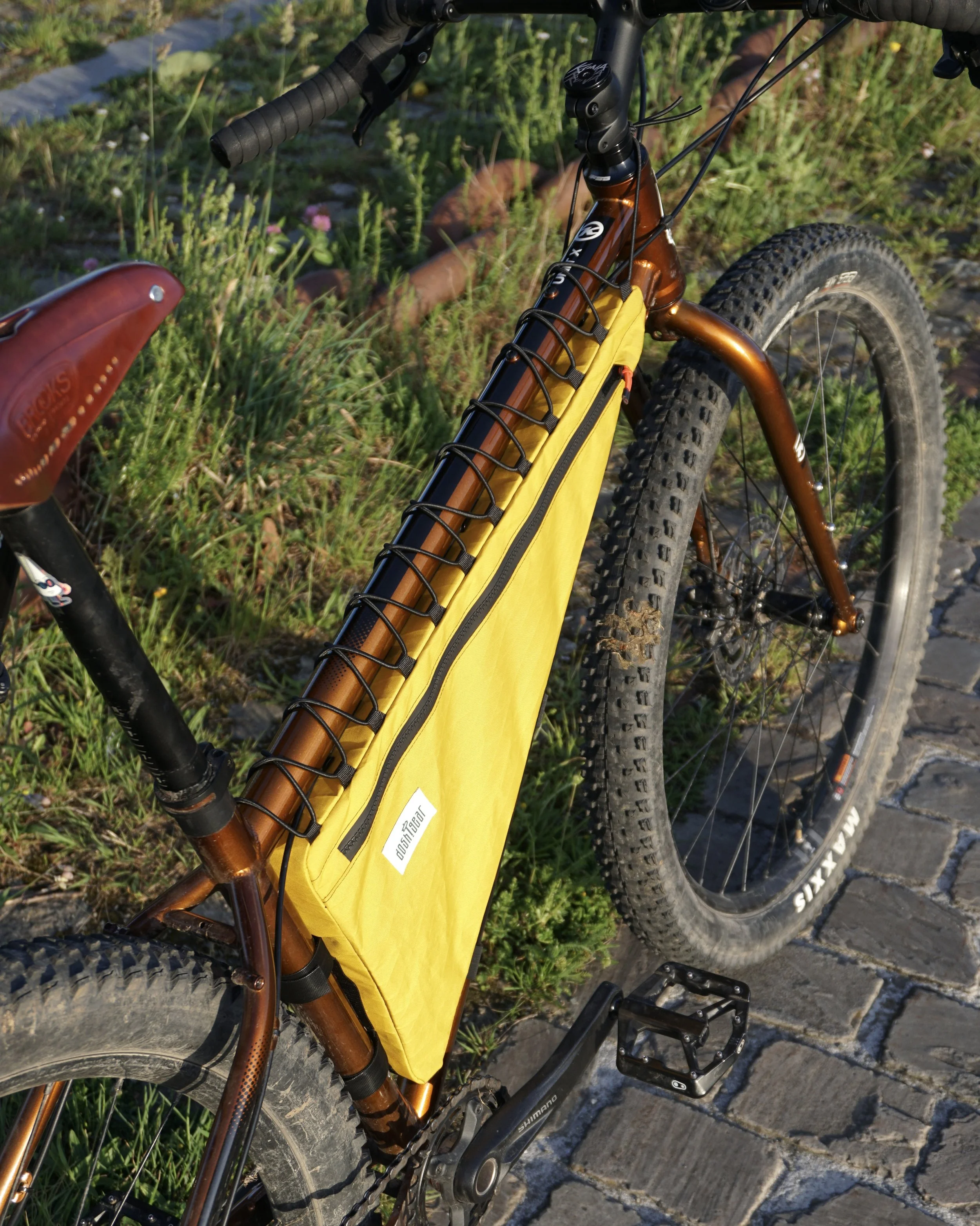 Kona Unit X steel mtb with Surly corner bars and a yellow custom made frame bag
