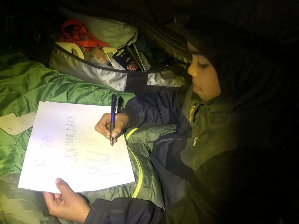 Param making the placard for summit, after recovering from his severe headache