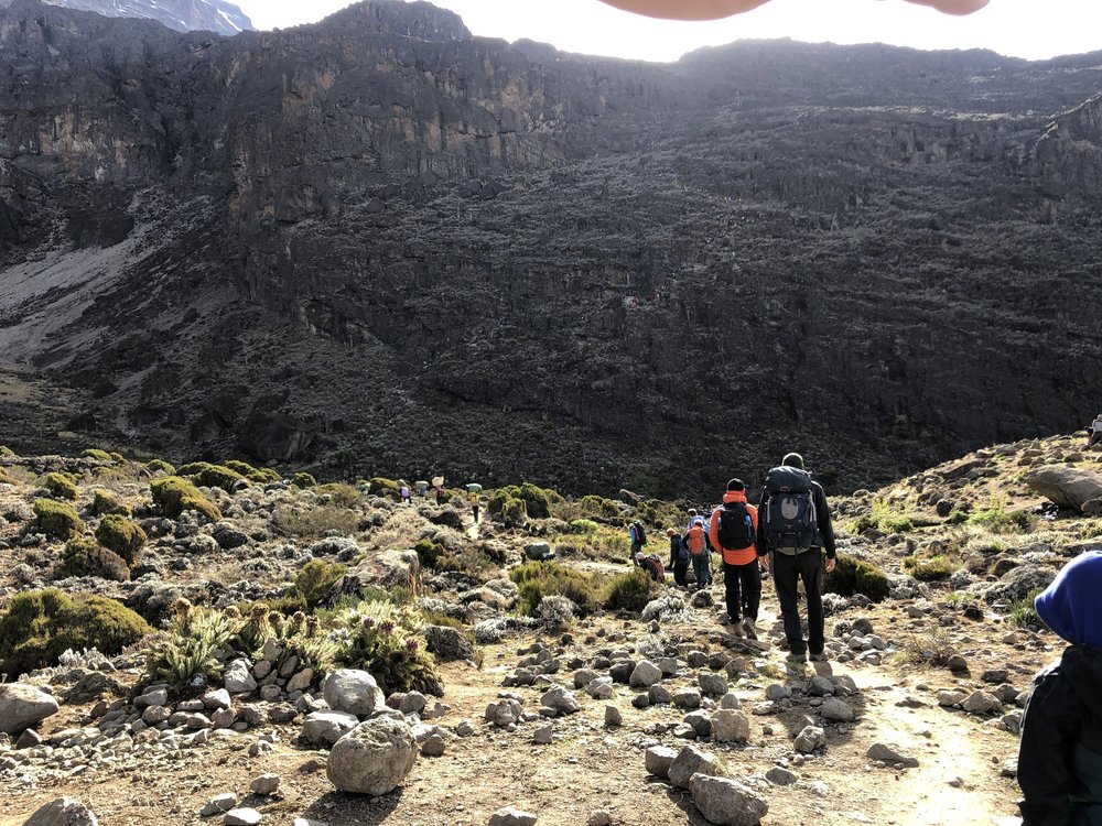 Climbers who started early, looking like tiny coloured dots on the Baranco wall