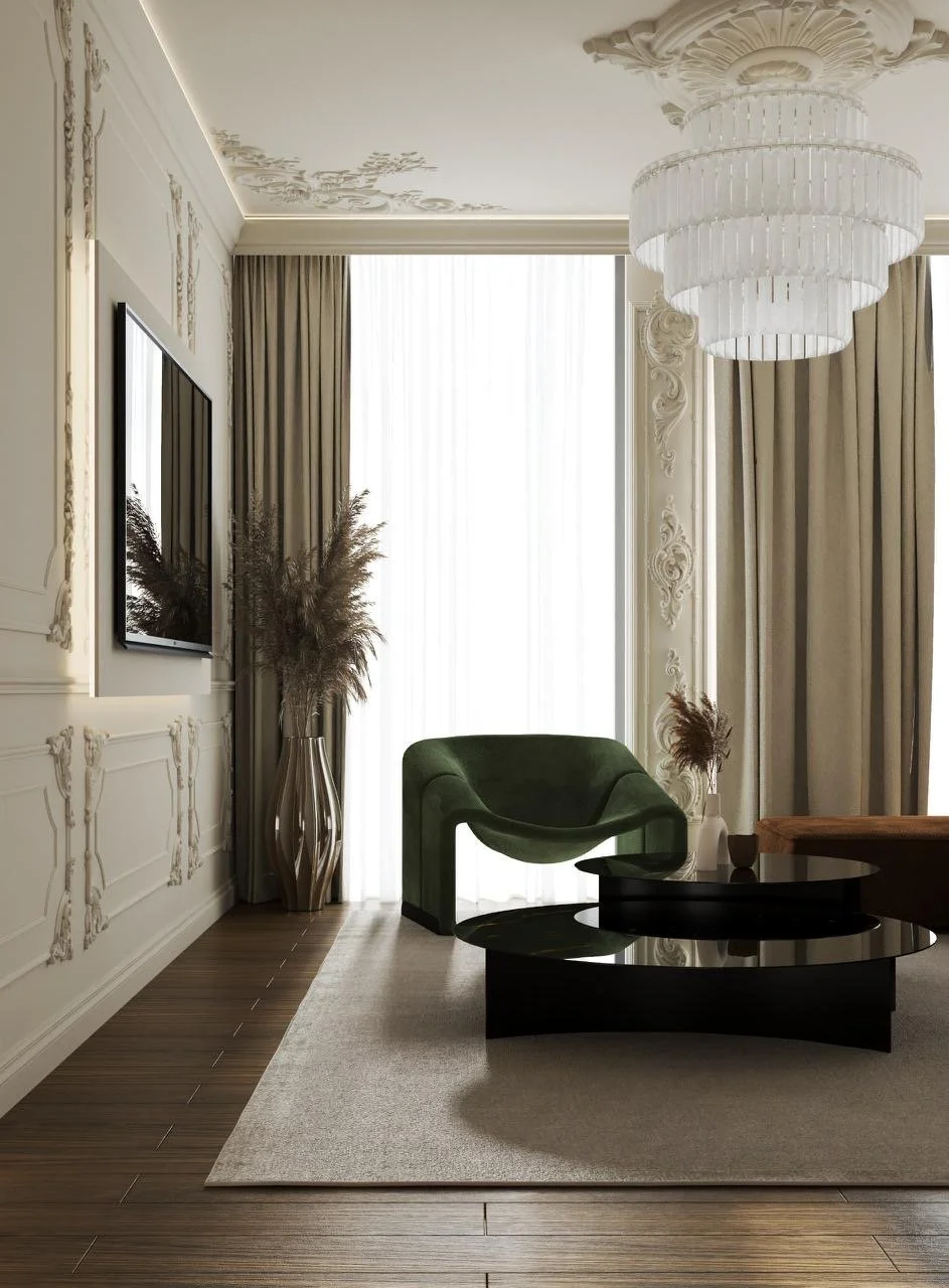 Elegant living room with ornate molding, green modern chair, black coffee table, beige curtains, and large chandelier.