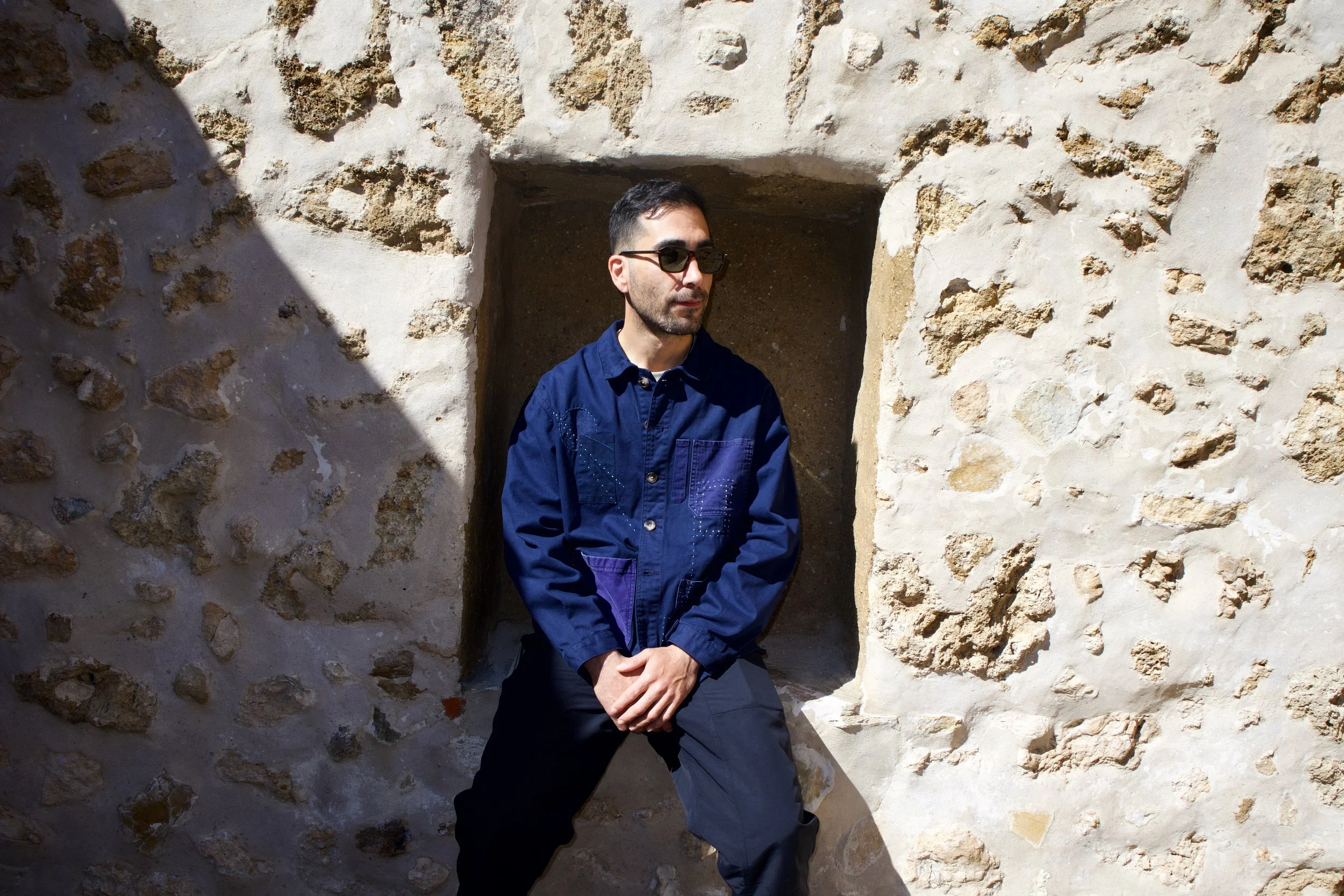 Chef Jason White sitting wearing Sack Coat uniform designed by Finery.