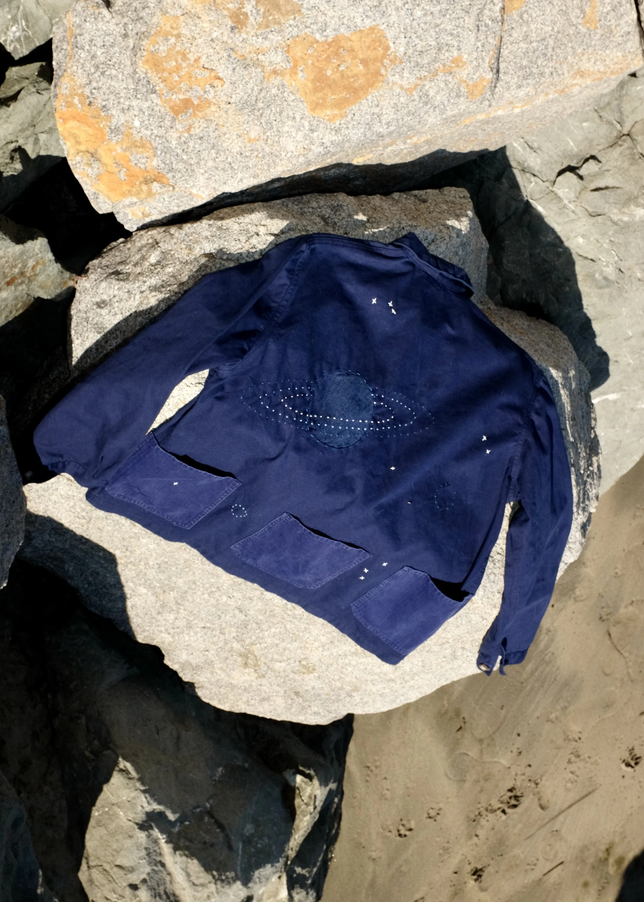 Flat lay of the Jason White Sack Coat uniform collaboration designed by Finery.