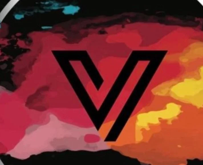 Abstract background with vibrant red, yellow, pink, black, and blue watercolor-like splashes, and a prominent black stylized letter V in the center.