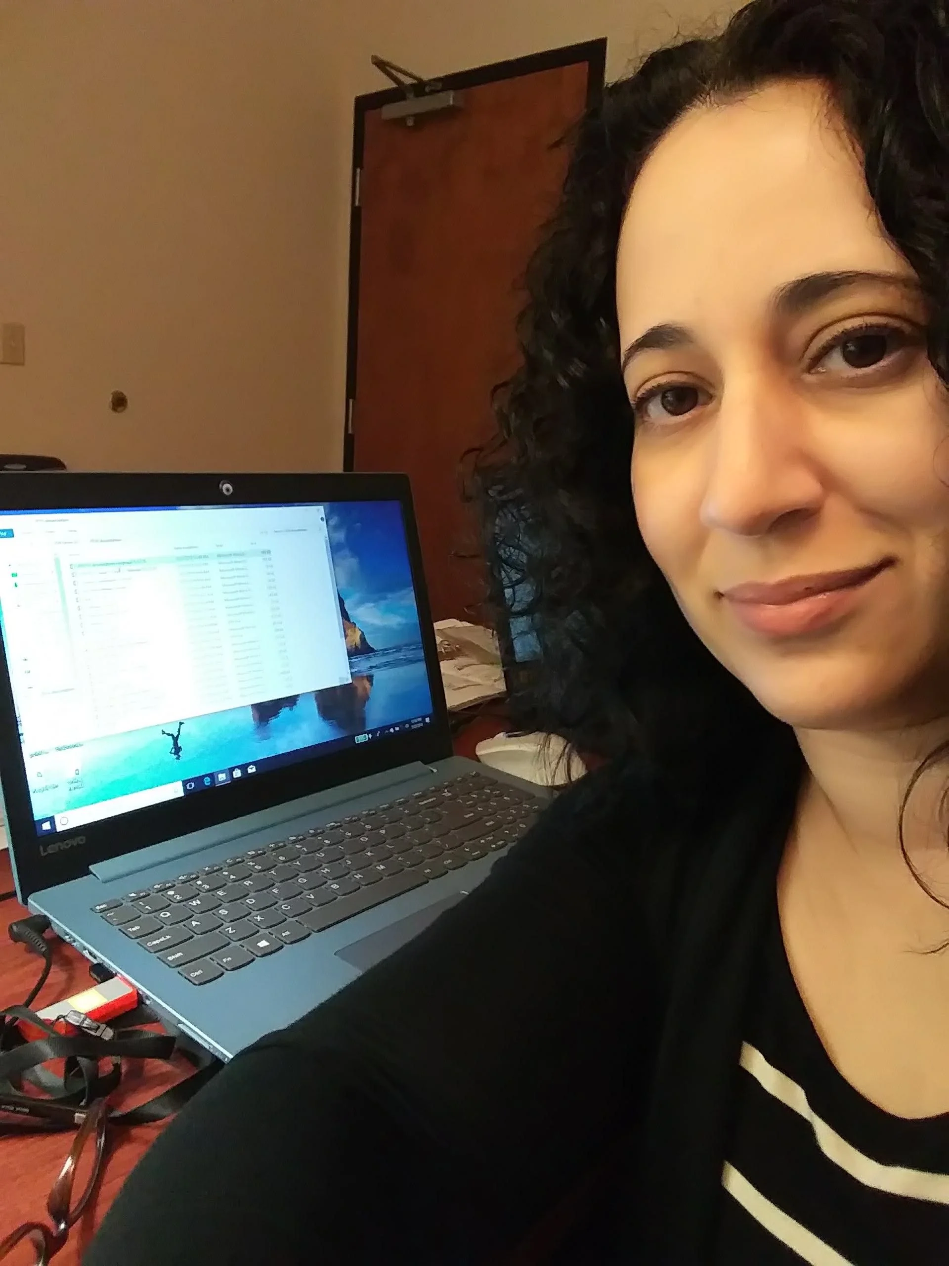 Dr. Allende working at a laptop in her then office.