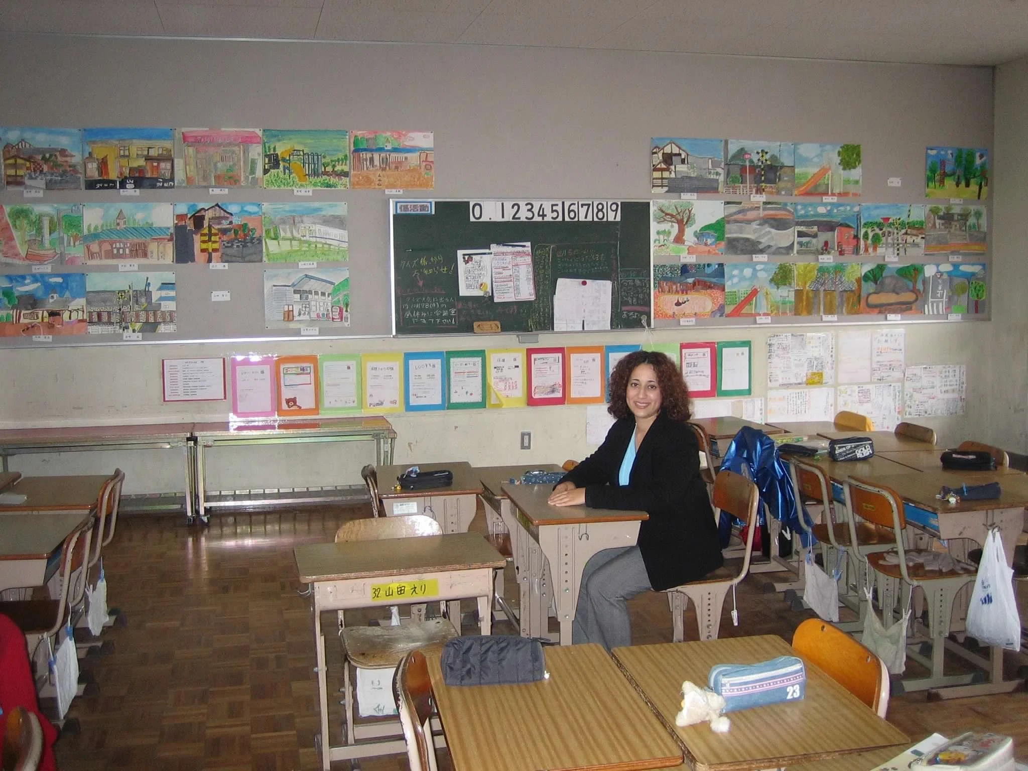 Dr. Allende seated in an elementary classroom in Japan.