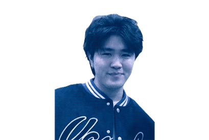 Portrait of a young man with dark hair smiling, wearing a dark varsity jacket with white trim.