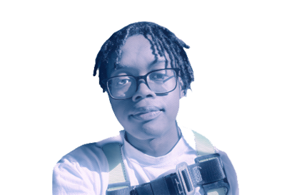 A young person with glasses and dreadlocks wearing a white shirt and holding a camera.