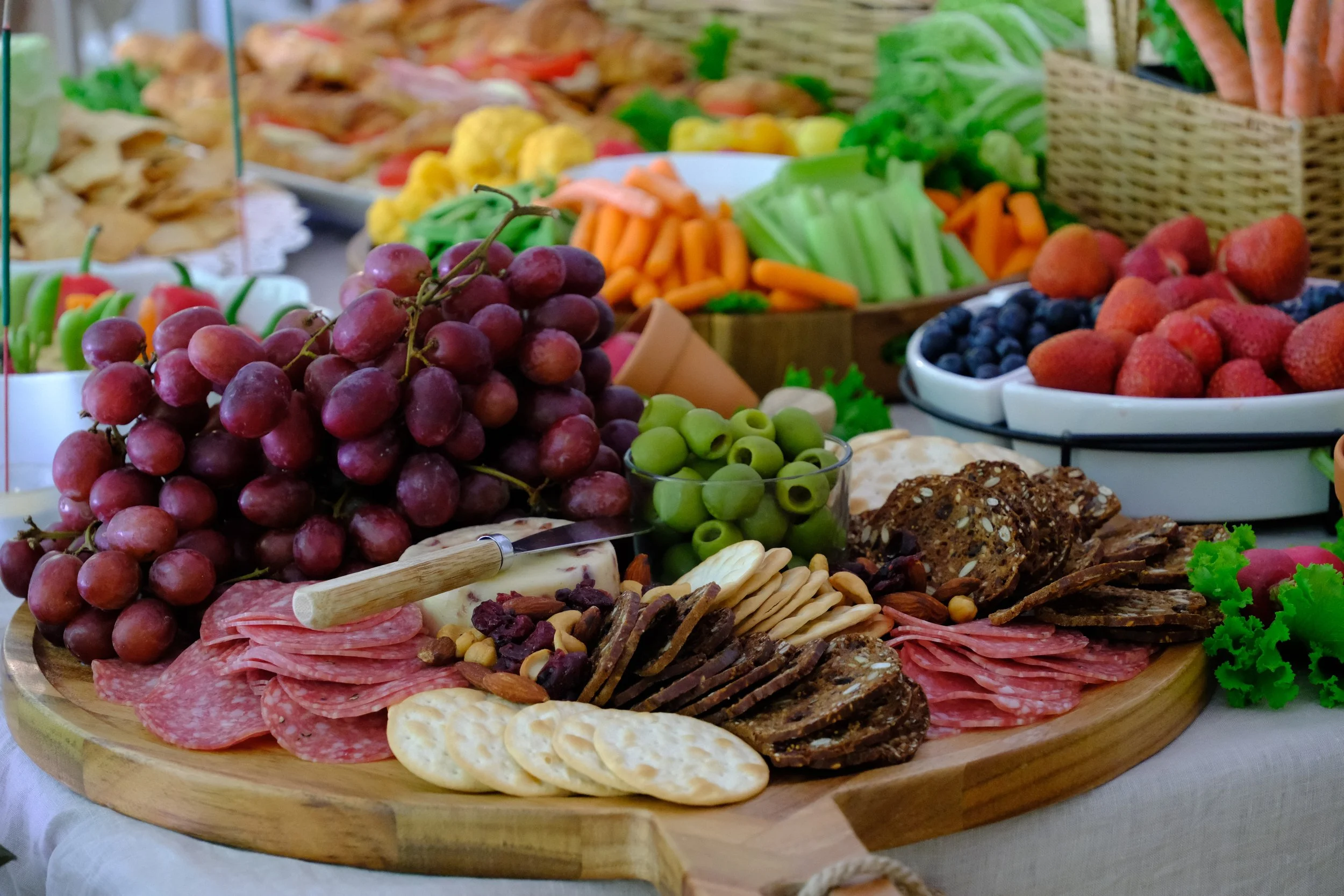 Our beautifully curated Peter Rabbit-inspired grazing table is a feast for both the eyes and taste buds. Overflowing with fresh fruits, artisanal cheeses, charcuterie, crisp vegetables, and gourmet crackers, this charming spread is styled with whimsi