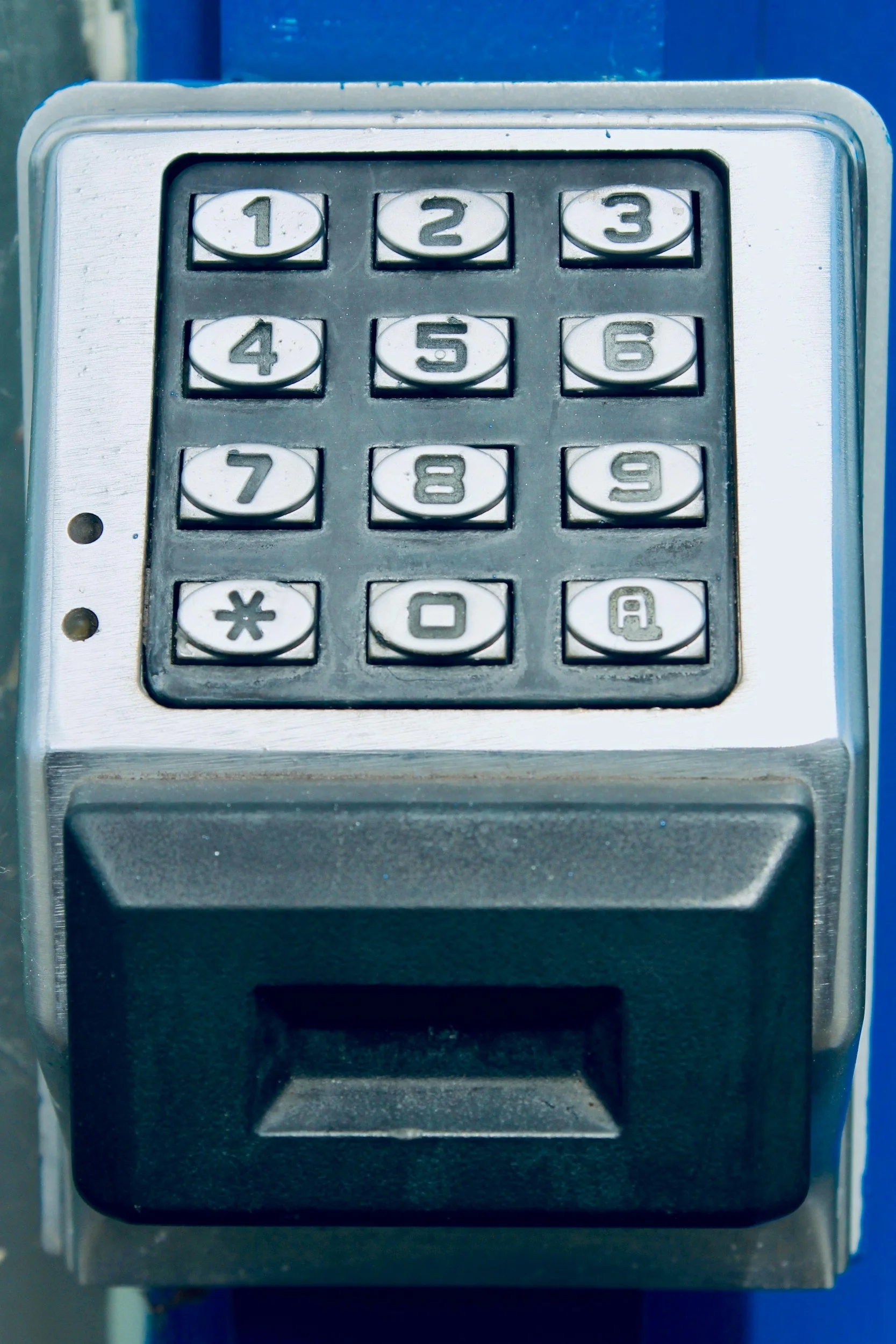Close-up of a parking meter with a numeric keypad.