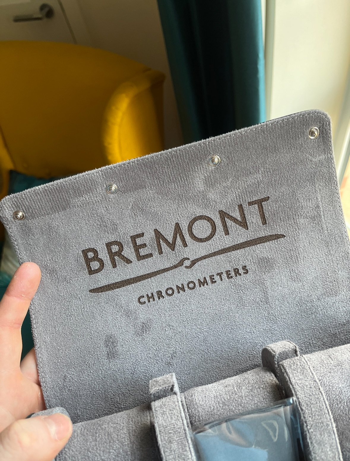 A close-up of a gray Bremont chronometer pouch with brand logo.