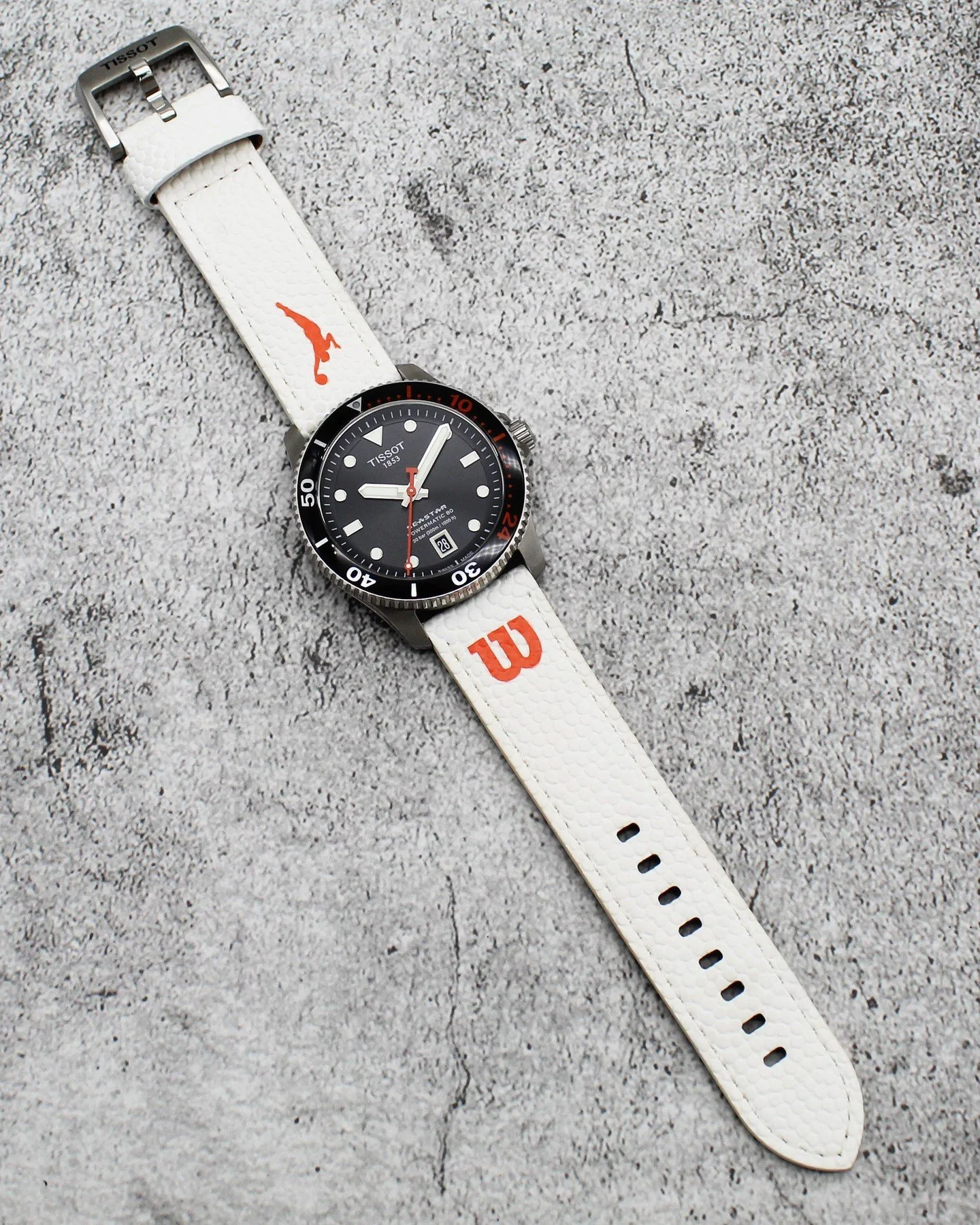 The Tissot Seastar Powermatic 80 WNBA Special Edition (Ref. T120.807.17.051.00) combines serious dive-watch capability with exclusive WNBA detailing. Featuring a bold black dial, sporty strap, and the reliable Powermatic 80 automatic movement

This o