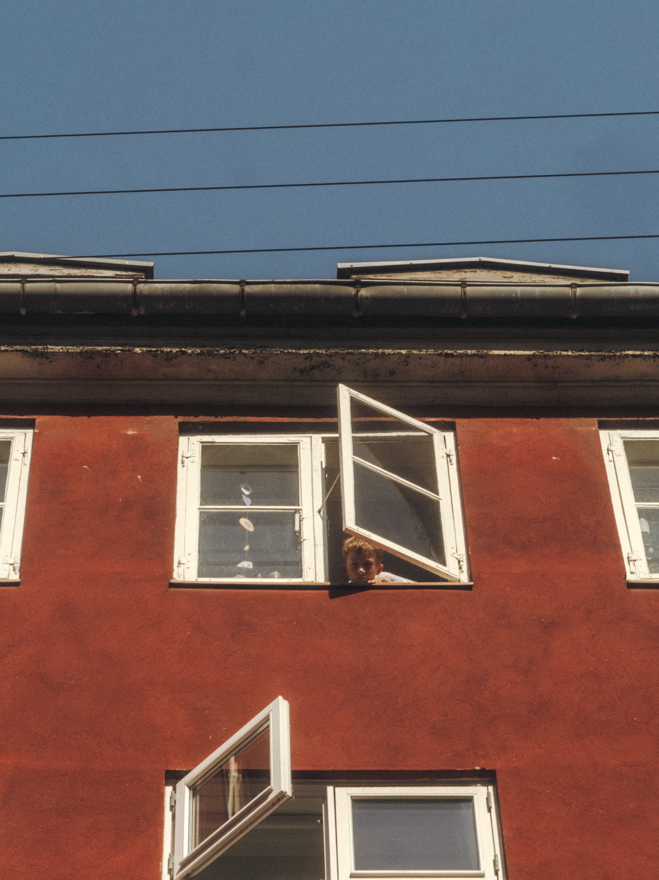 Boy in window. Copenhagen 2024