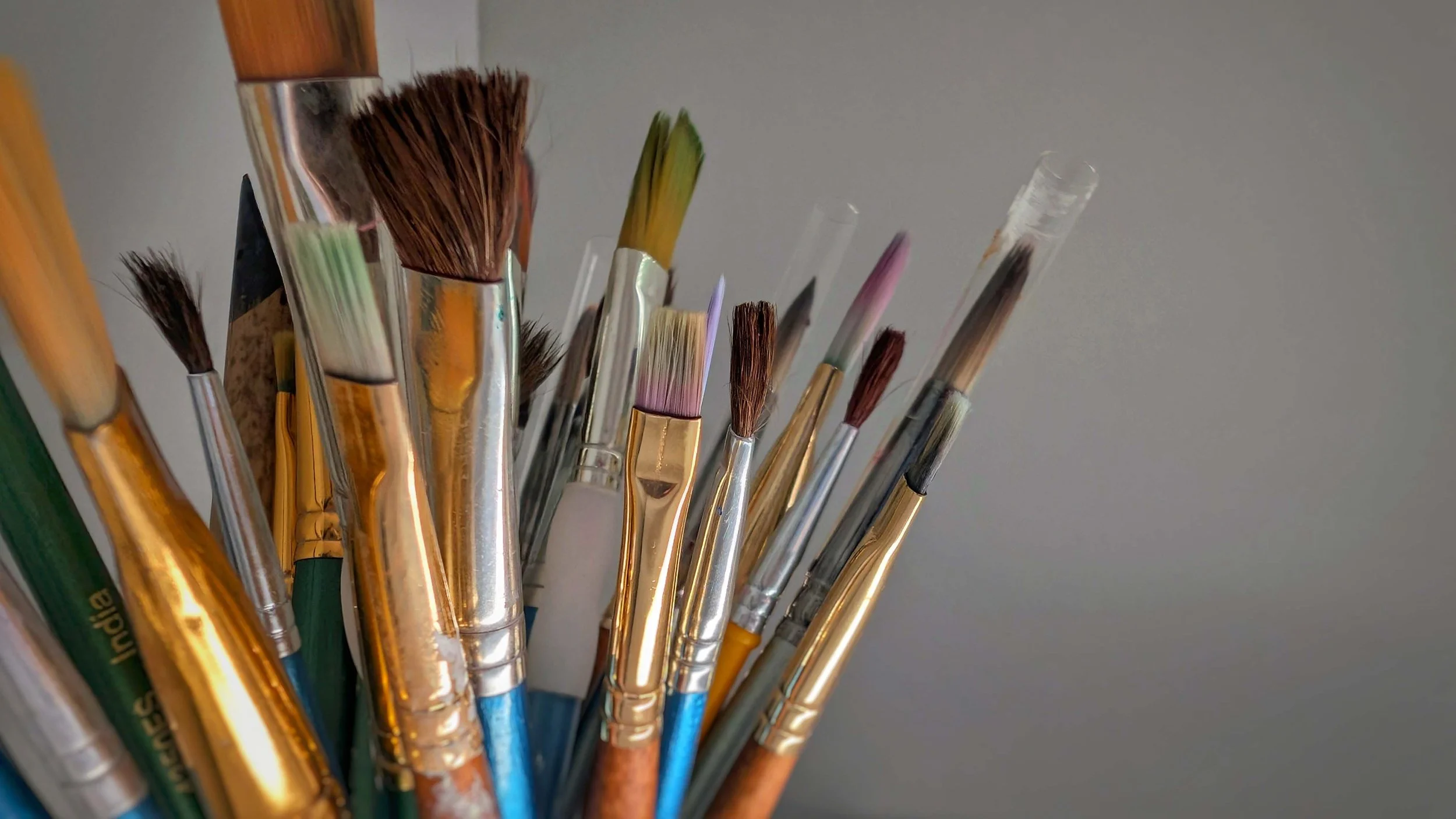 Close-up of paintbrushes in a creative art therapy studio at Illuminated Pathways in Philadelphia, Pennsylvania symbolizing expression and emotional healing through art.
