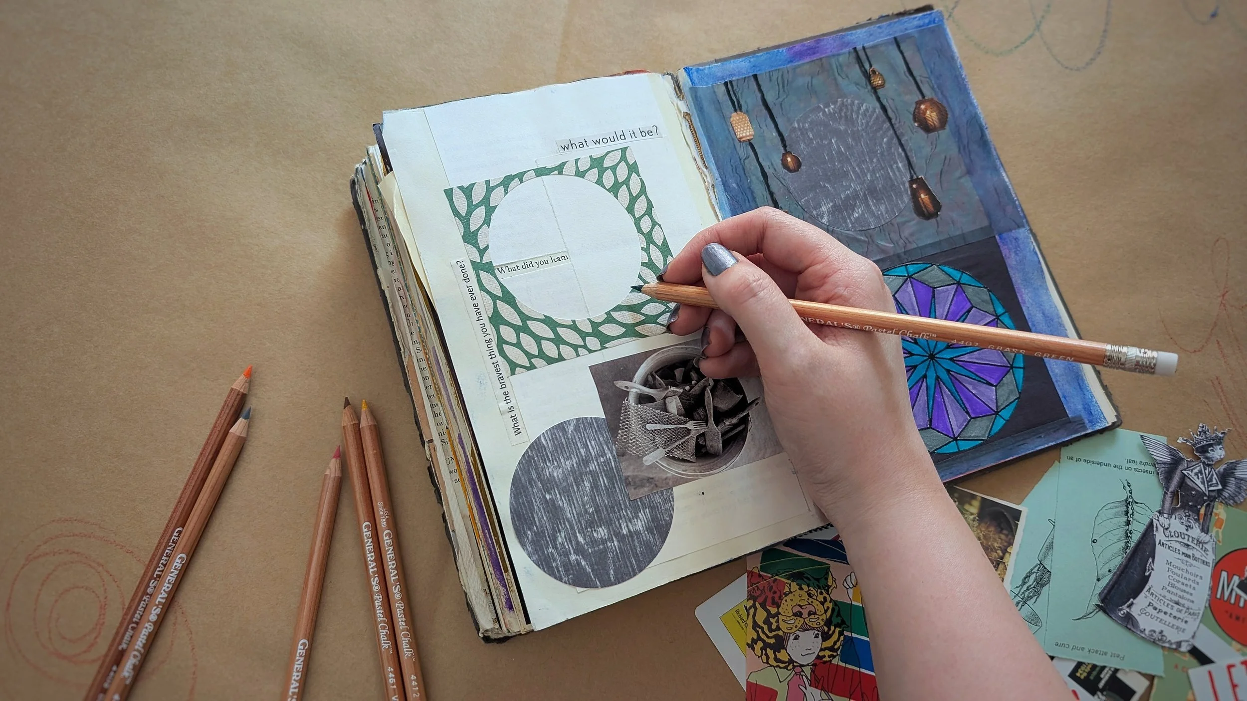 Hand creating art therapy collage in sketchbook during trauma therapy session — Illuminated Pathways, Philadelphia, Pennsylvania Art Therapy and EMDR practice.