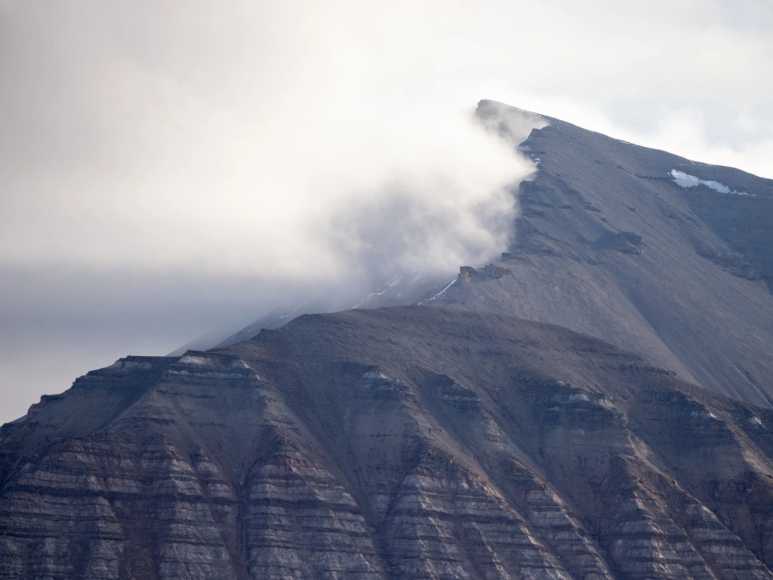 "Black and White." Dramatic black cliffs span the shoreline of Billefjorden.  In summer, the frigid Arctic waters are passable by boat, giving a rare view of the glaciers and the wildlife that survives these harsh conditions.  