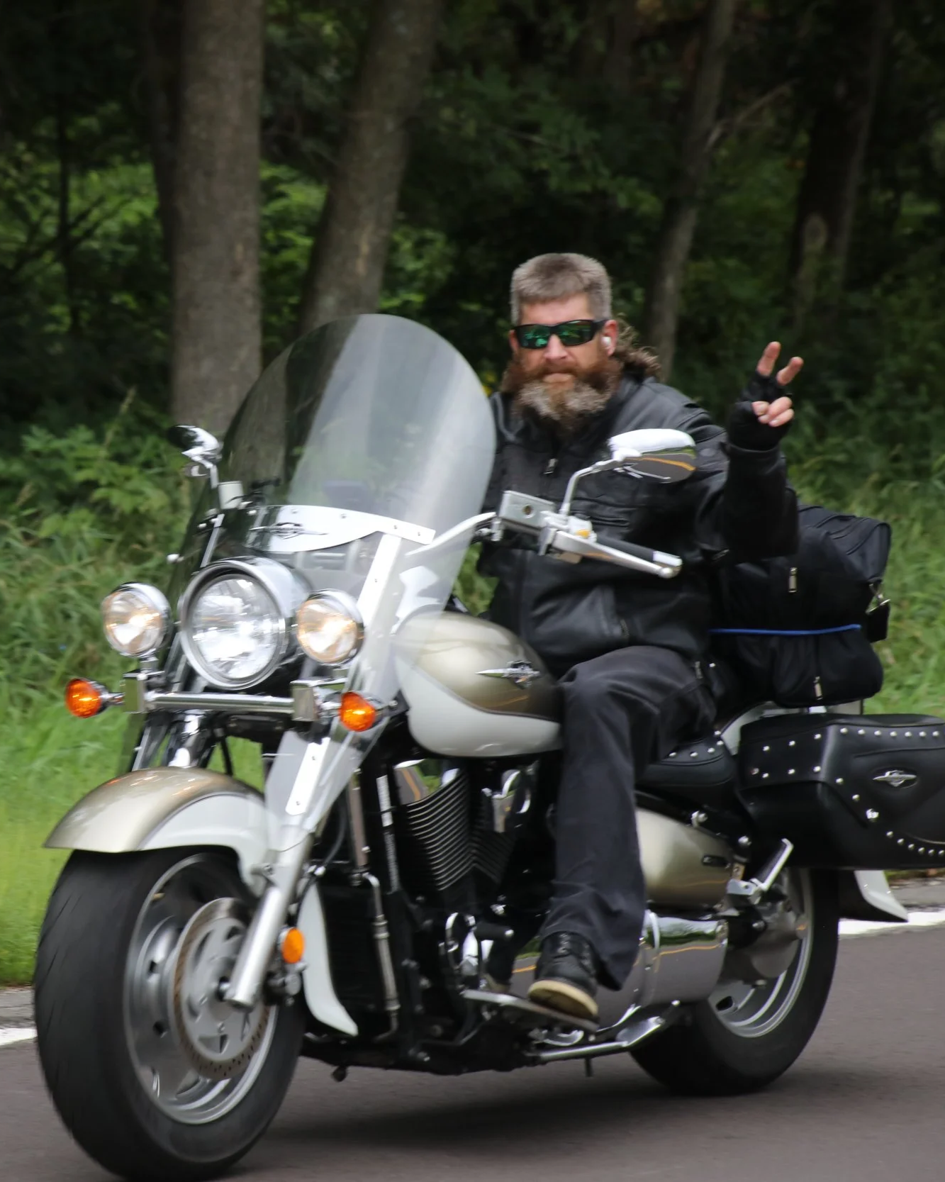 Participant riding giving the peace sign
