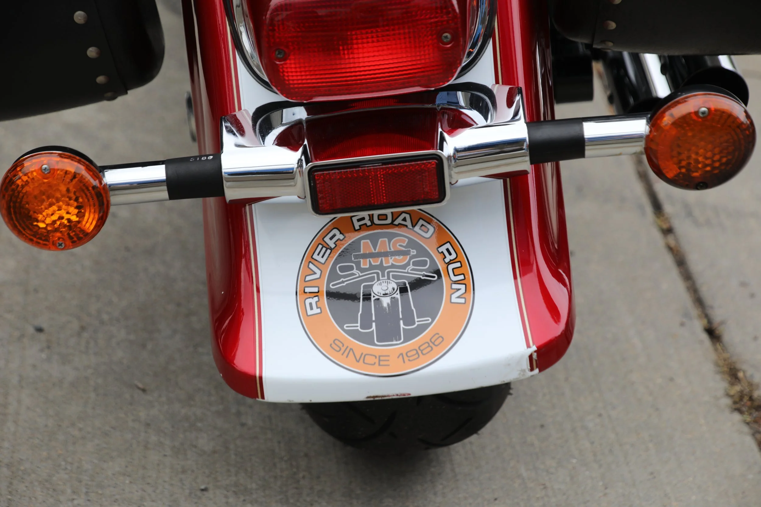 Participant's motorcycle with the MS River Road Run logo on the back