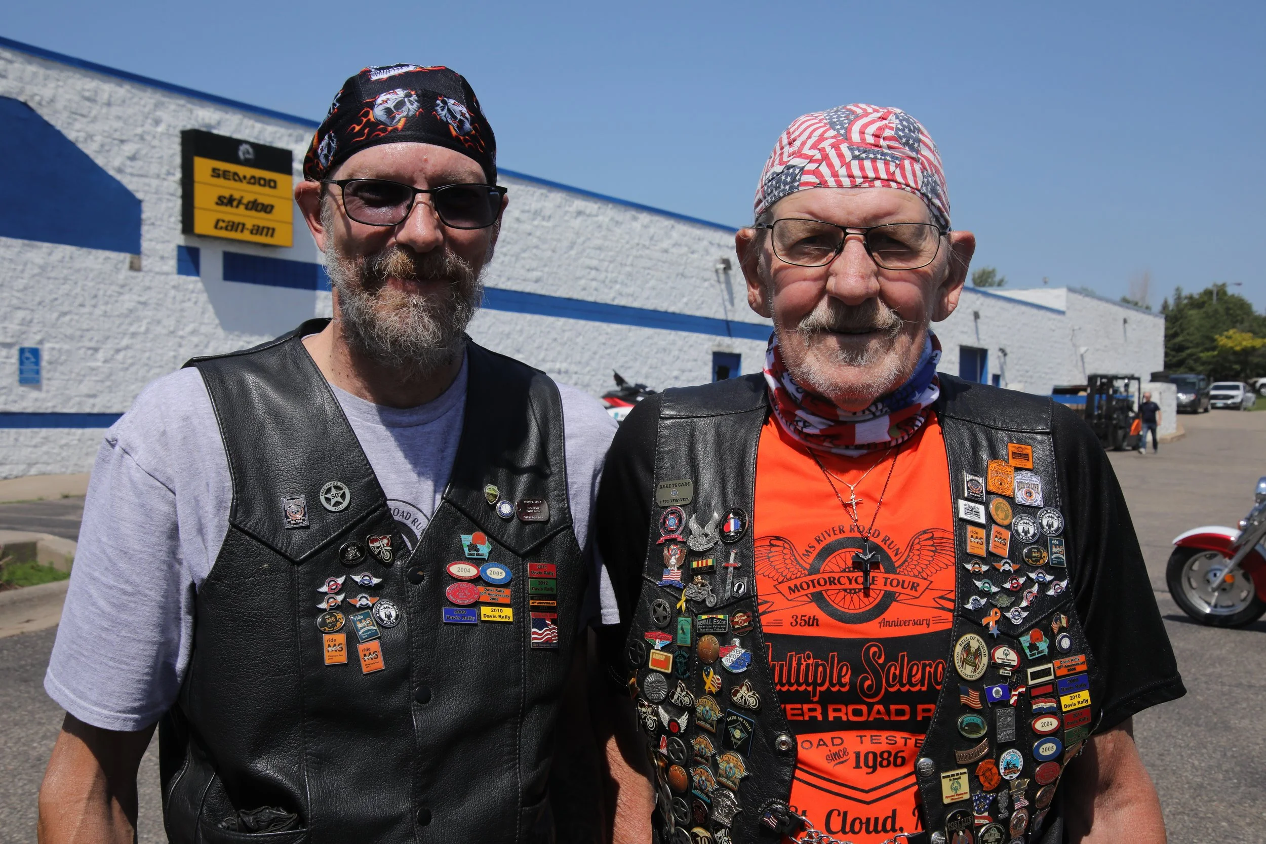 Two participants wearing motorcycle vest with lots of decorative buttons