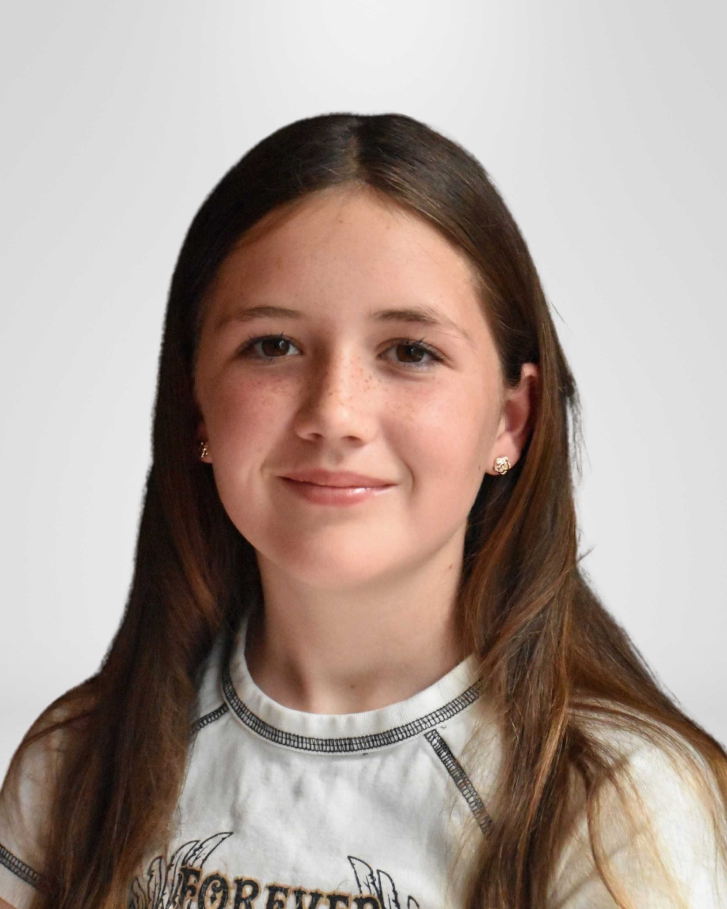 Portrait of a young girl with long brown hair, wearing a white T-shirt with black trim and small earrings.