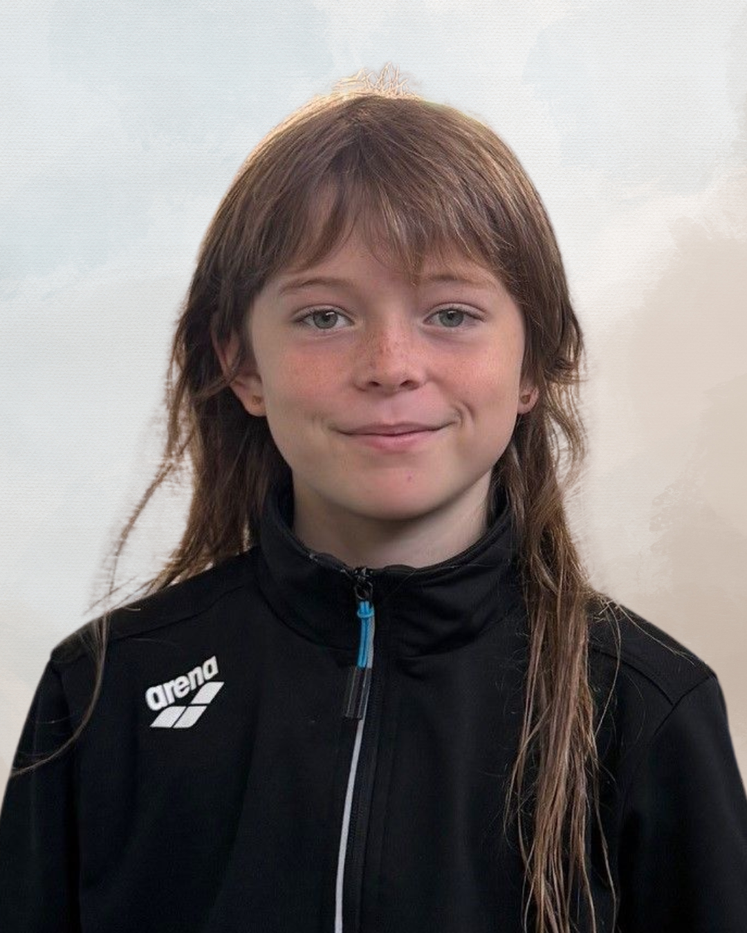 A young person with long, brown hair wearing a black athletic jacket with a blue zipper and the 'Arena' logo on the chest, standing against a plain, light-colored background.