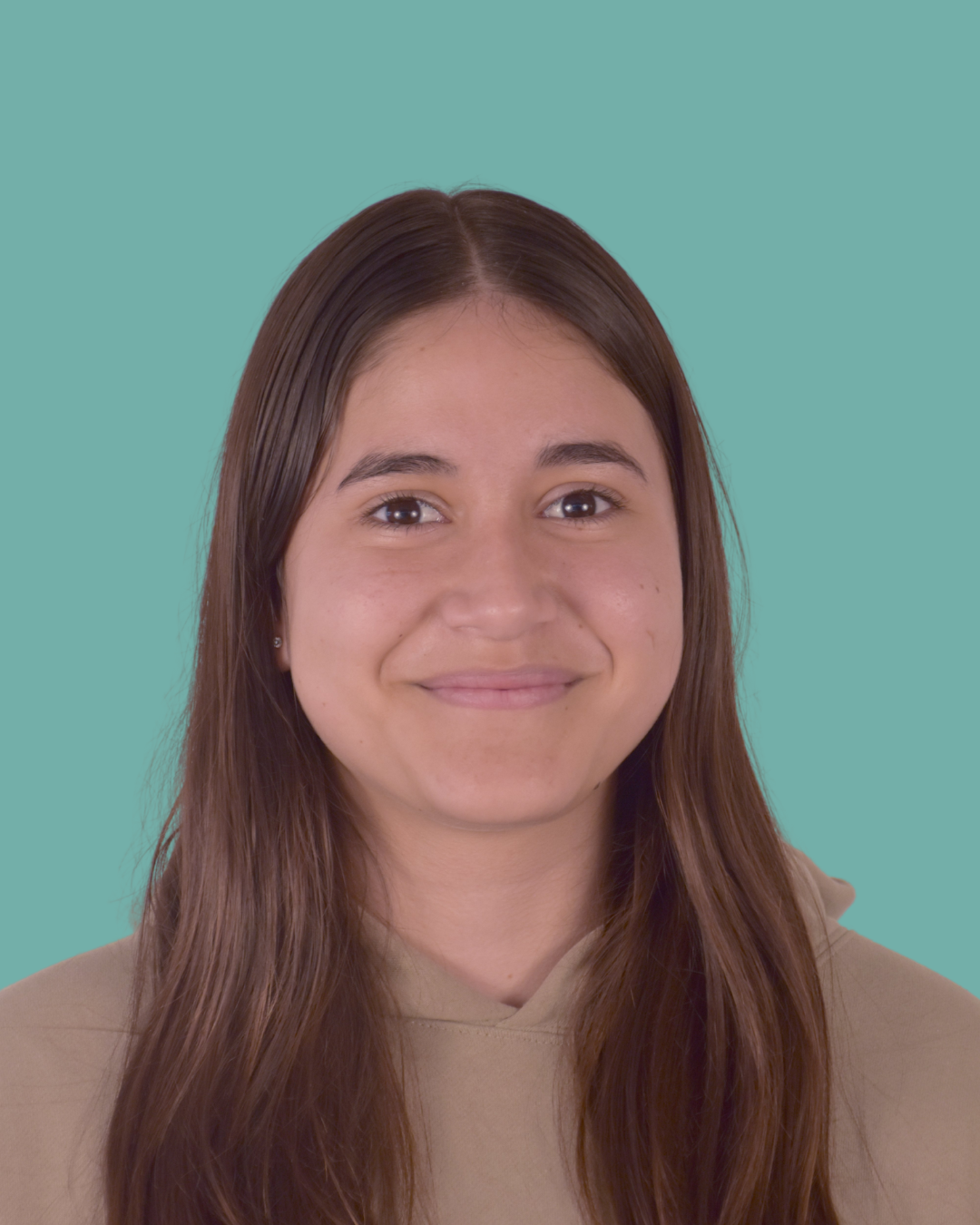 A young woman with long brown hair smiling at the camera, wearing a beige hoodie, against a teal background.