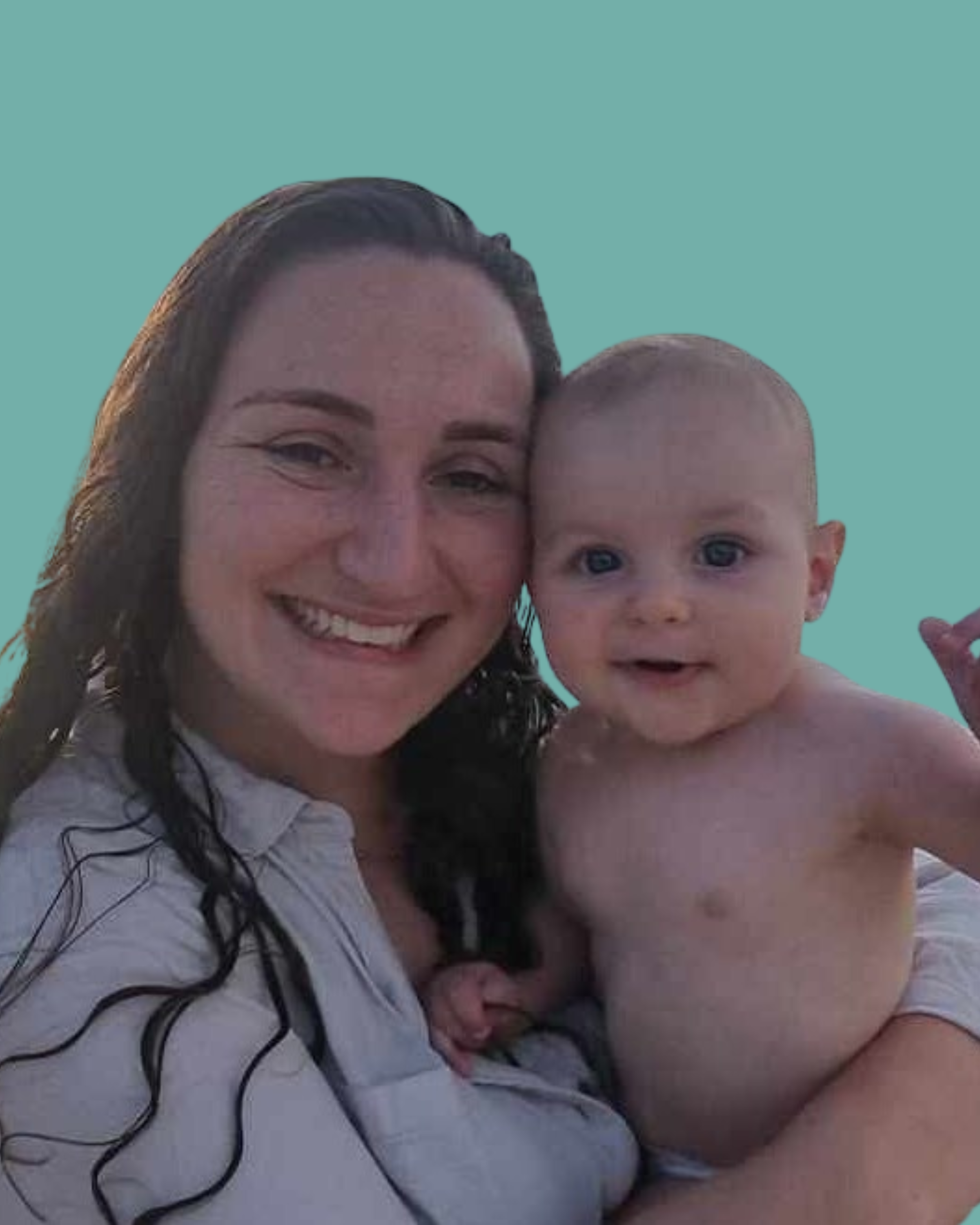 A woman with long wet dark hair smiling and holding a baby boy with a shaved head and blue eyes, both looking at the camera against a teal background.