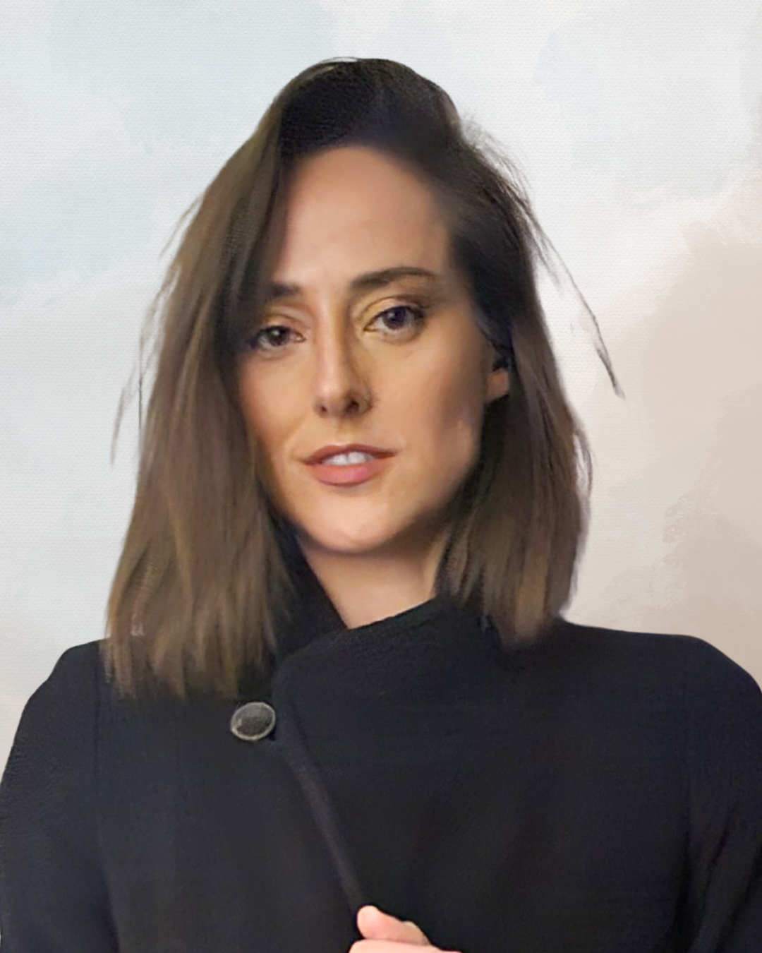 A woman with shoulder-length brown hair, wearing a black top, looking at the camera with a slight smile, against a light background.