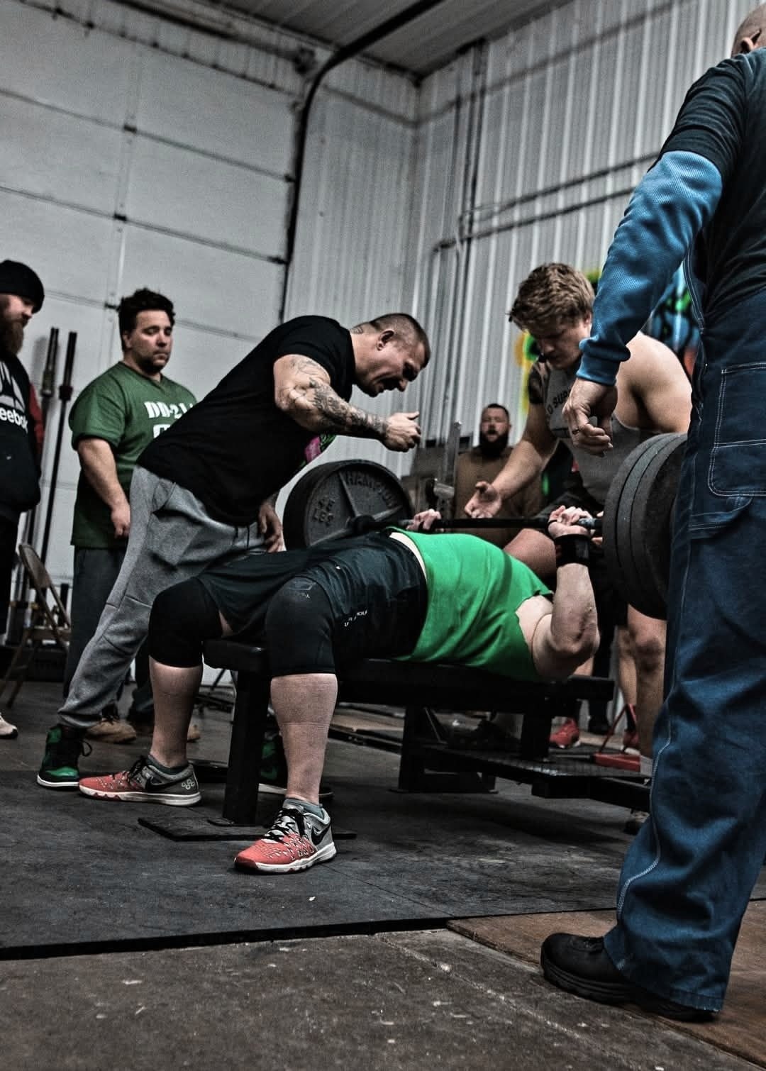 Lifters at Bench Blast lifting weight with help of spotter at Alpha Evolution in Newark