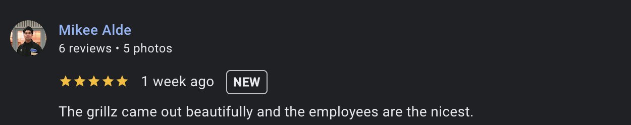 Screenshot of a Yelp review by Mikee Alde, rating five stars, praising the their custom grillz  and employees.