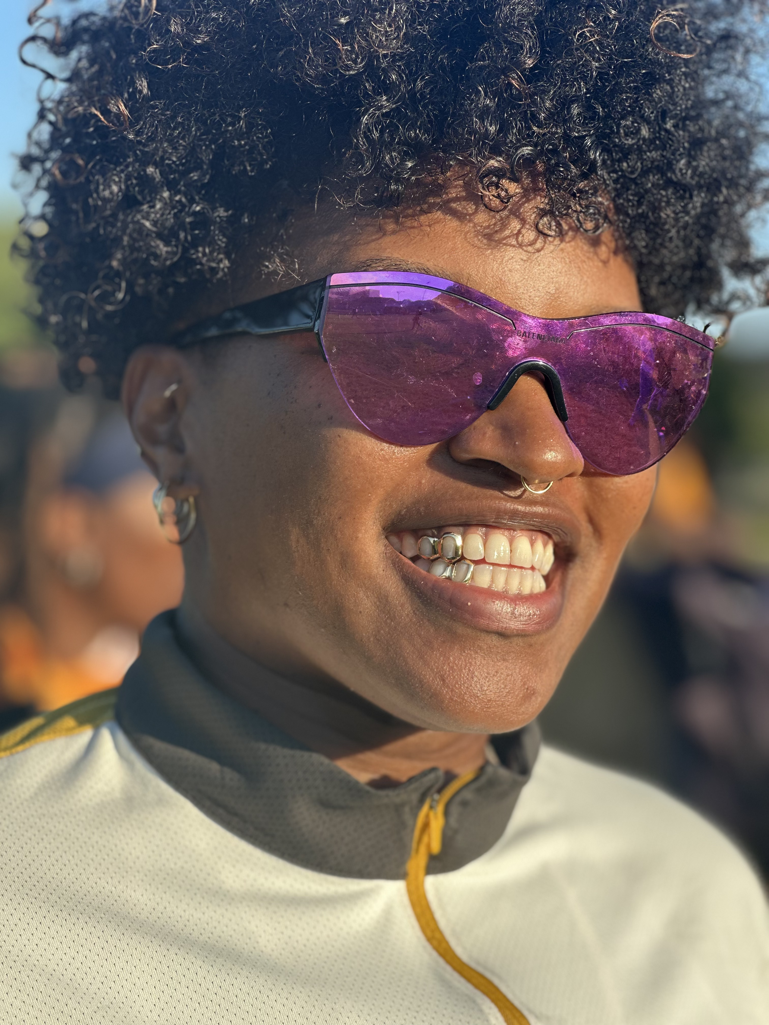 Close-up of a smiling woman wearing her 2pc top and bottom open face grillz on the south side of Chicago.