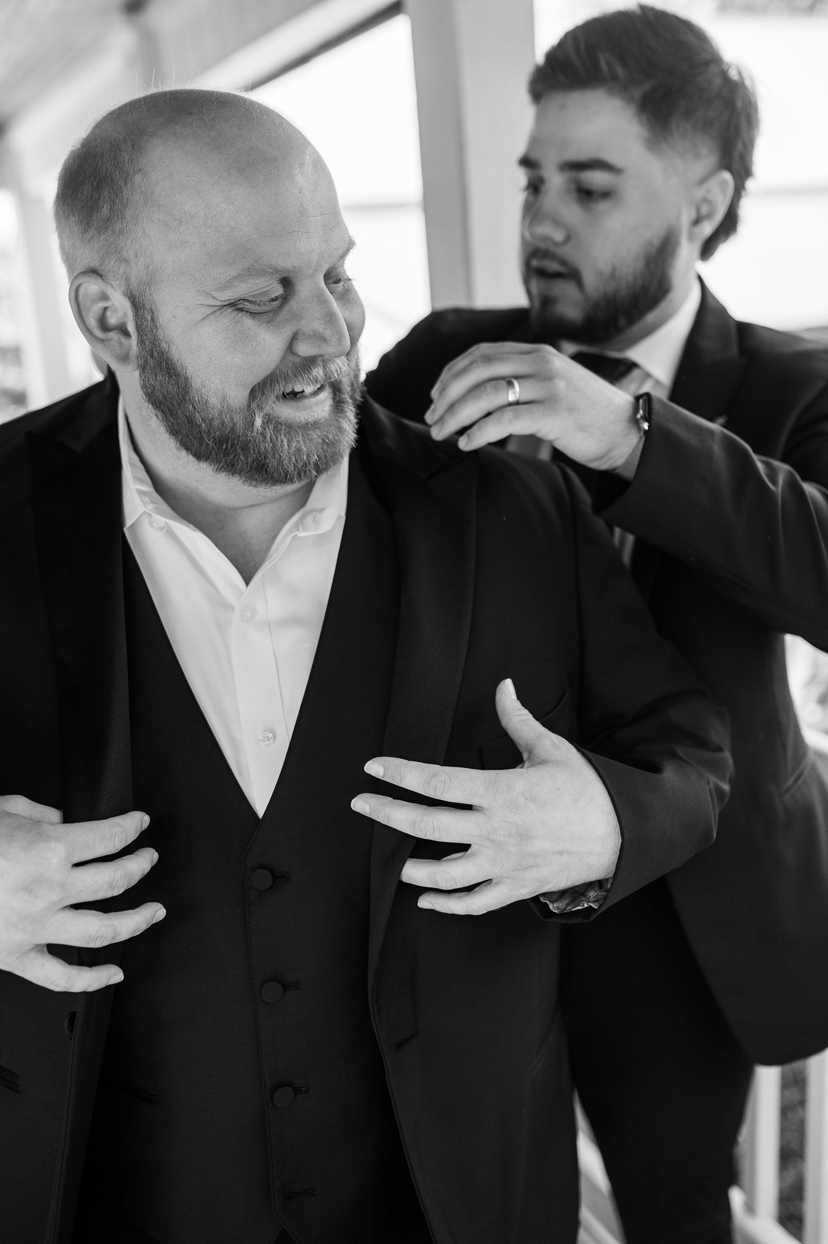 Groom putting on jacket at the Hope Glen Farm in Cottage Grove, Minnesota.