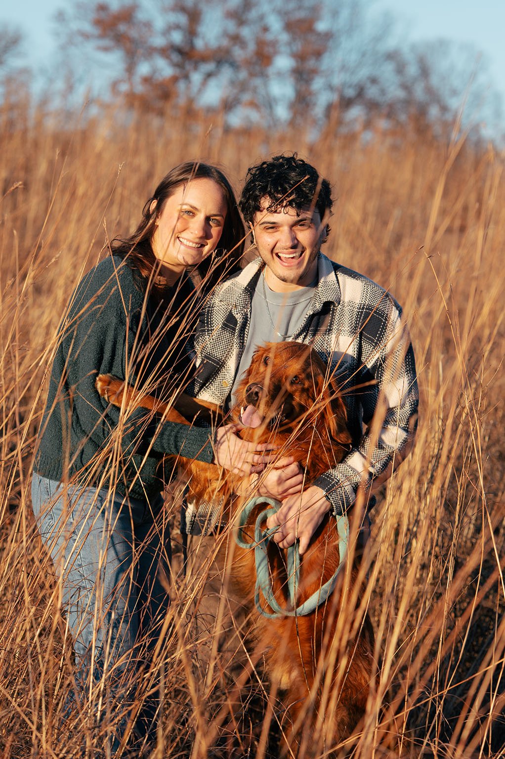 Fall portrait of couple in grass at Lebanon Hills park with their Golden Retriever.