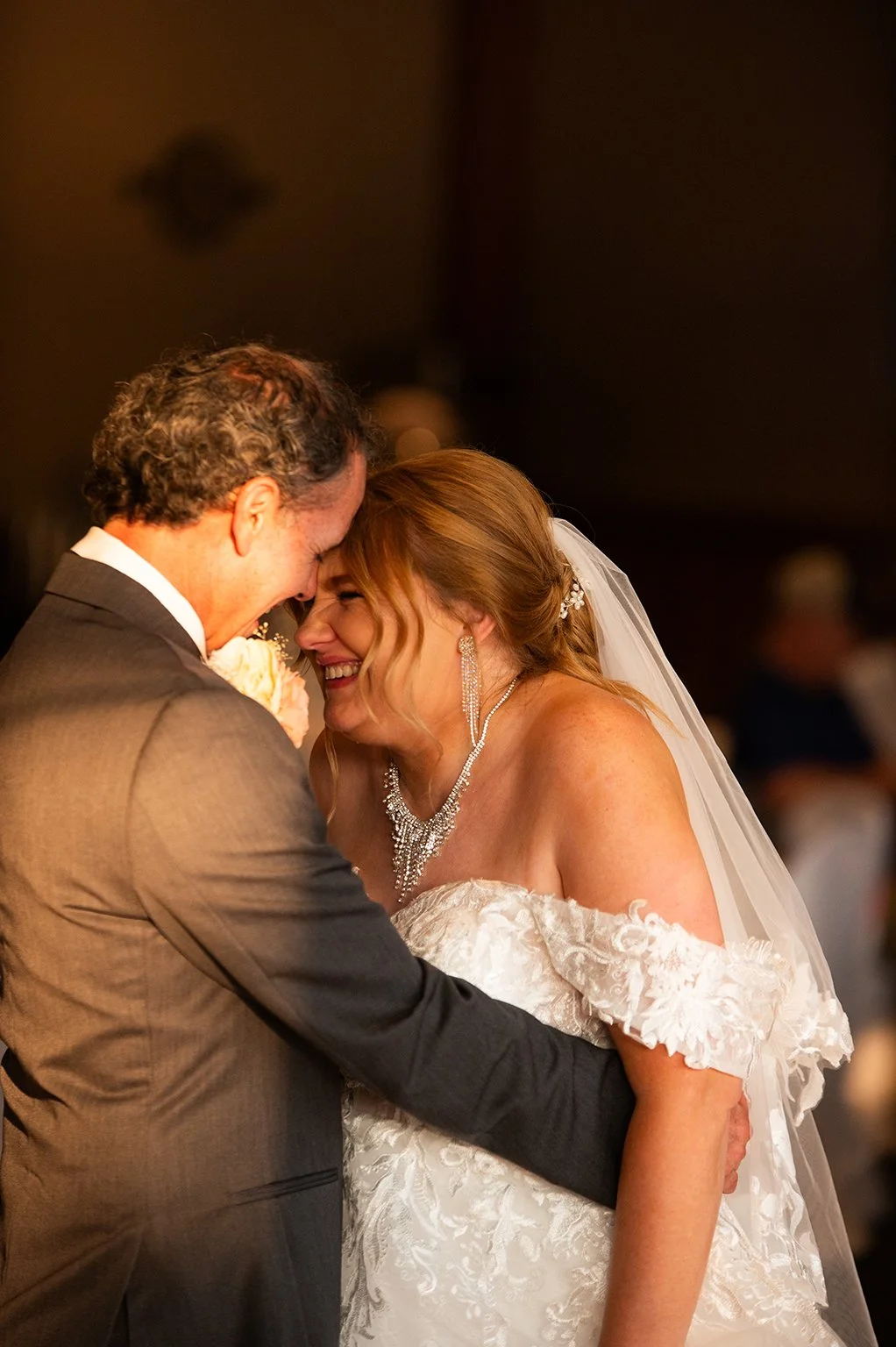 Bride and groom embracing and laughing at the Pettibone Resort in LaCrosse, Wisconsin.