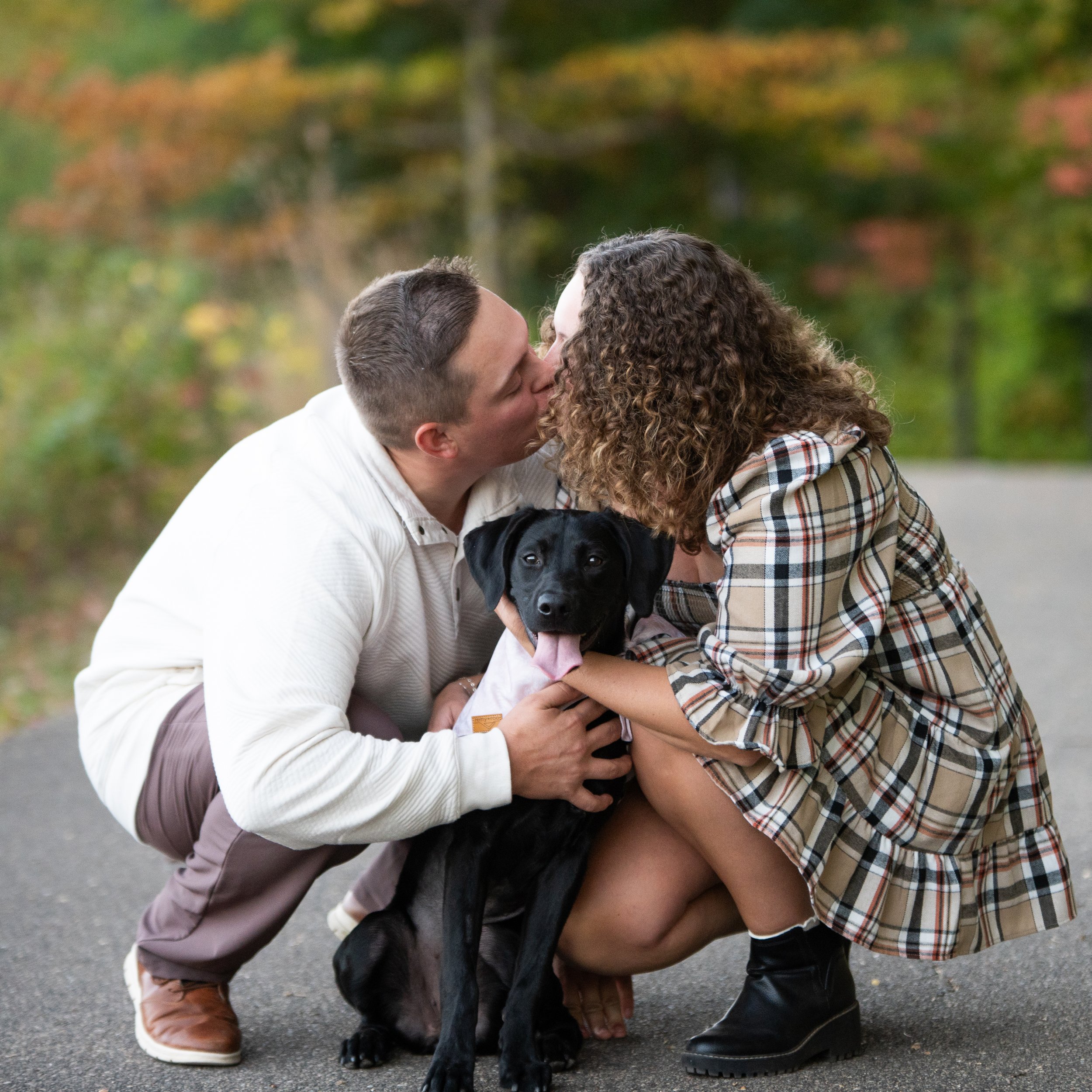 Fall engagement photos with couple and black lab at Jeffers Pond, in Prior Lake, Minnesota.