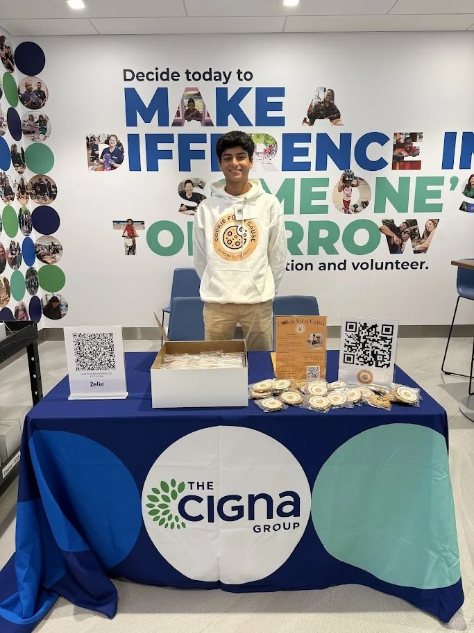 Cookie for a Cause founder Vihaan Kamath at a Cigna community event, raising awareness for children's healthcare and nonprofit cookie fundraising
