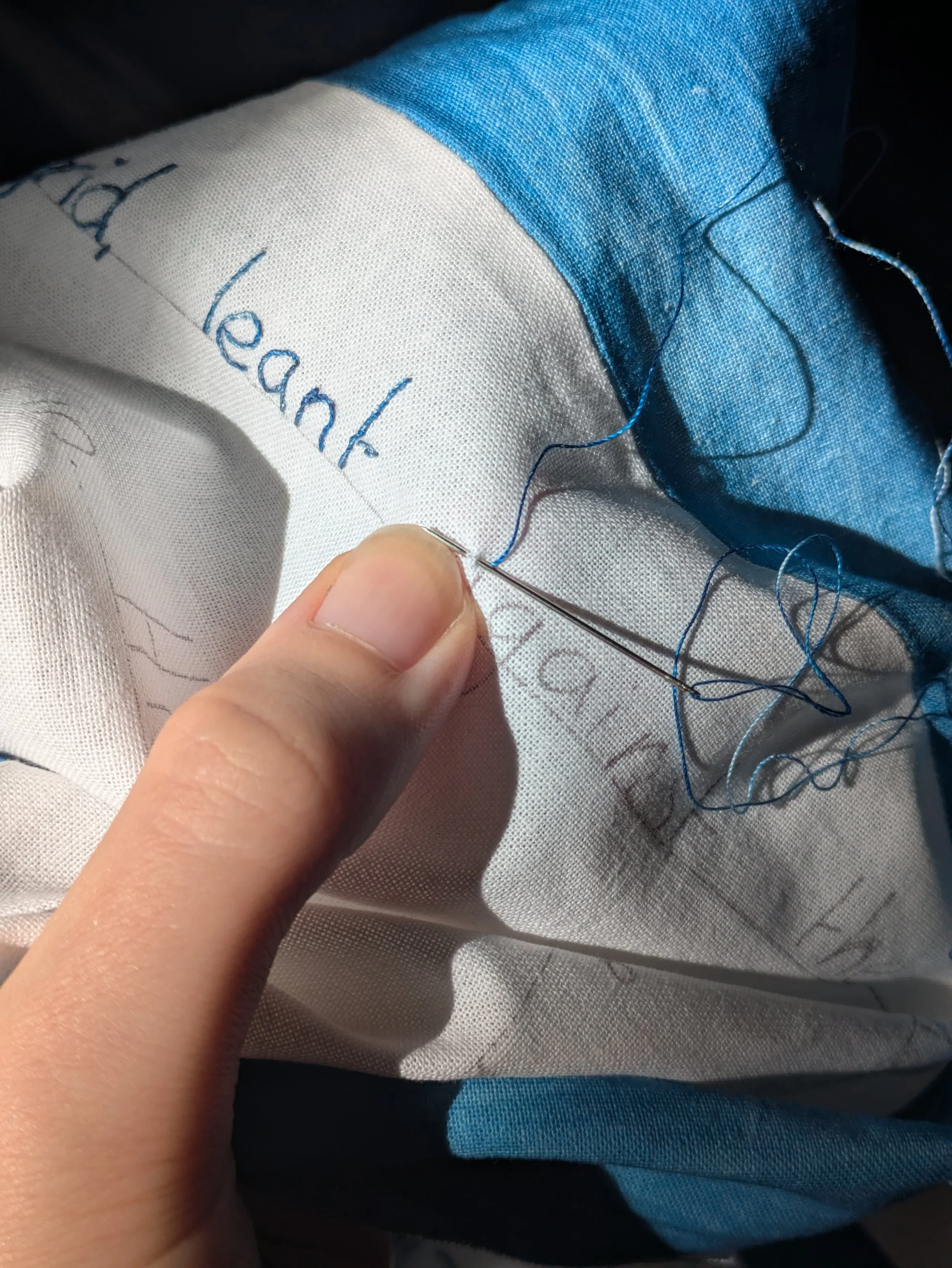 All text is hand embroidered using a stem stitch.