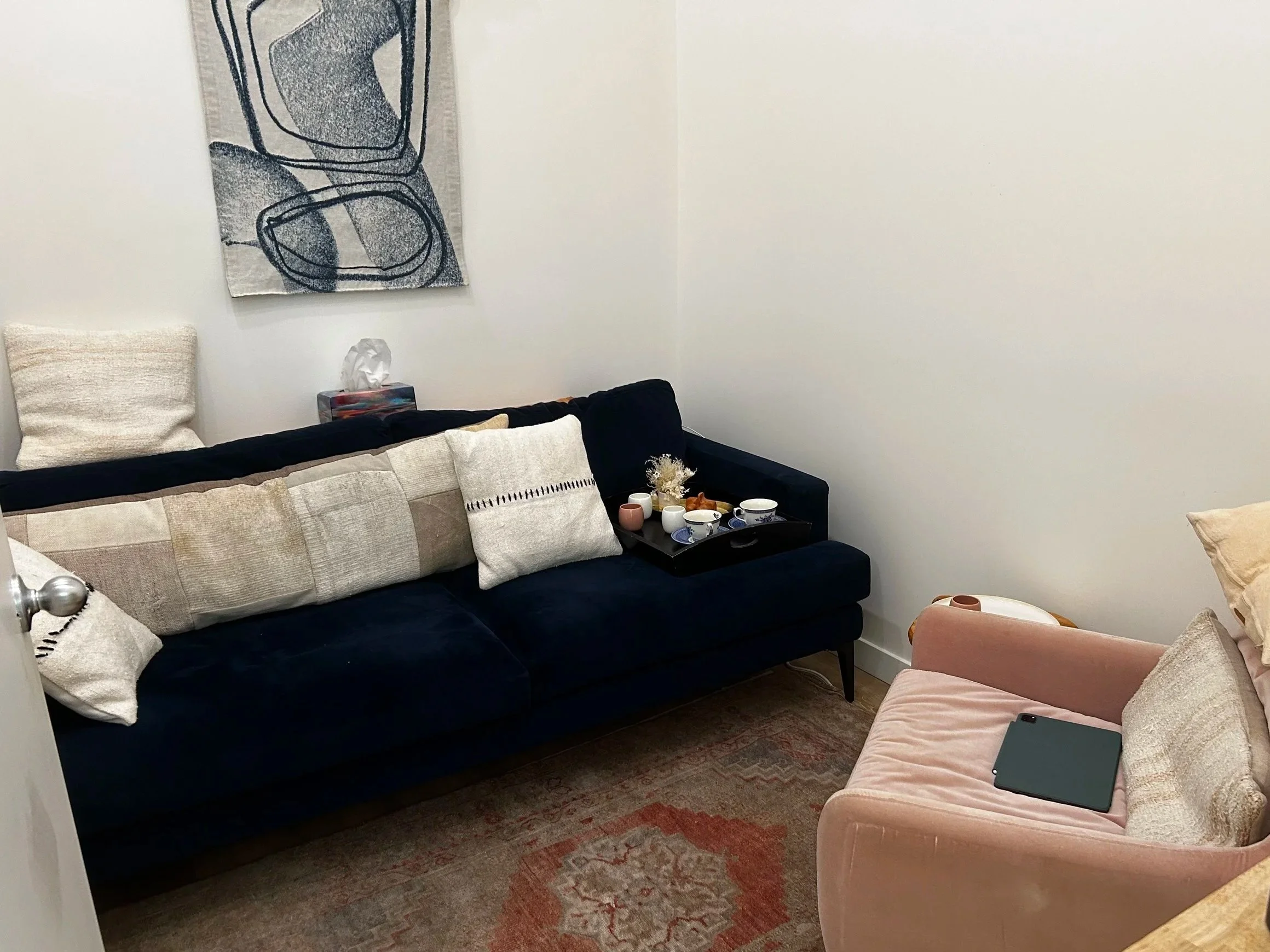 In person therapy office with a couch and chair