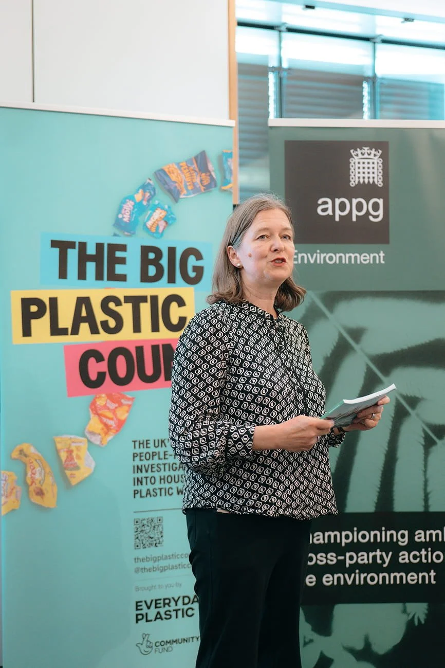 An MP speaking in front of a banner reading 'The Big Plastic Count'