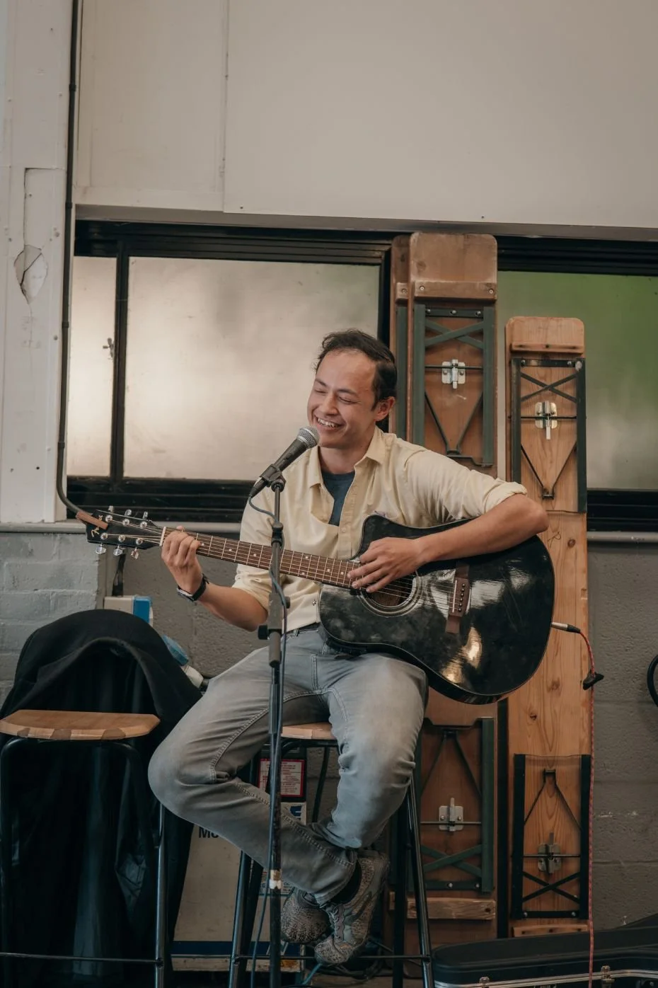 Man smiling while playing the guitar